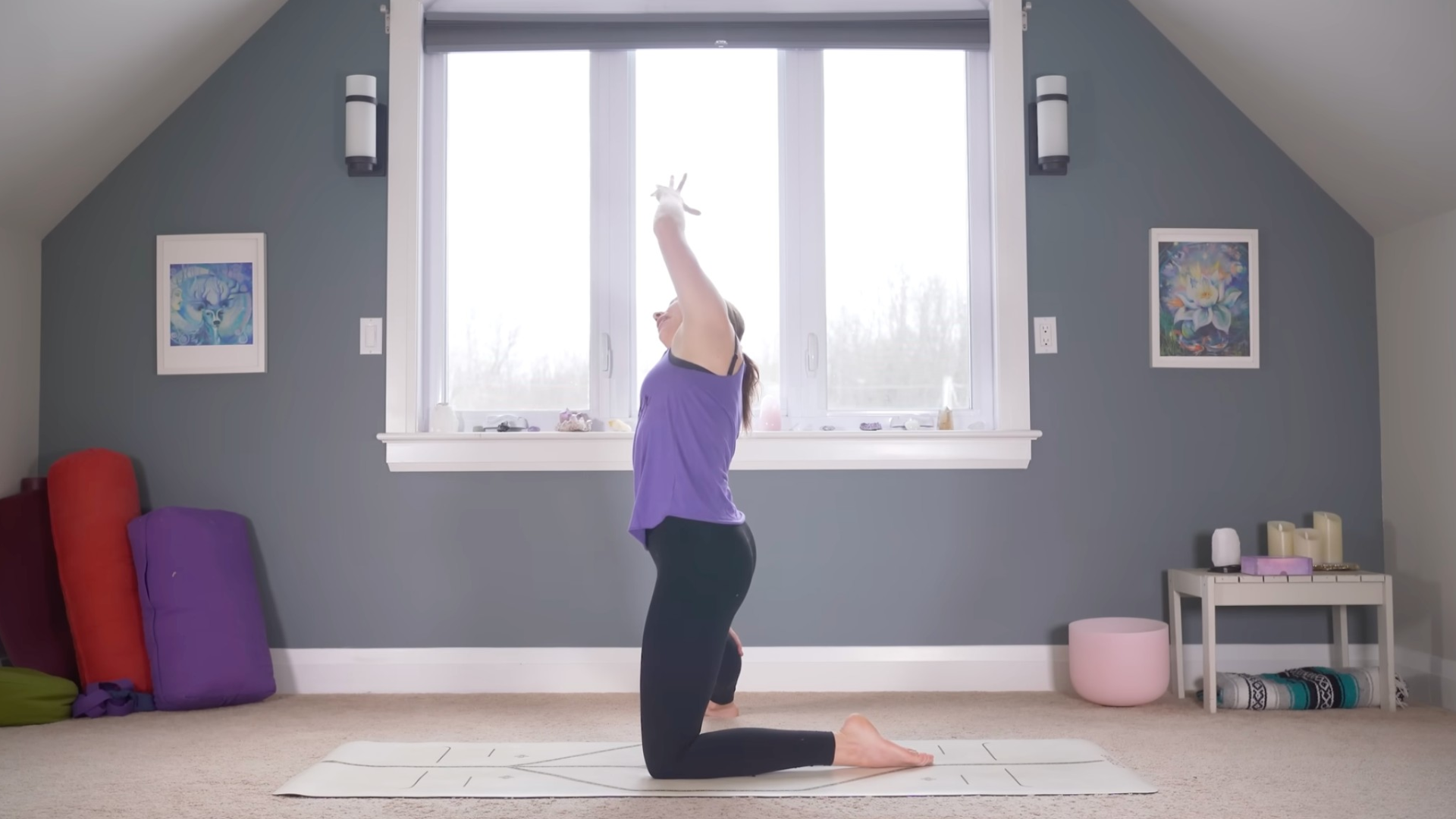 Woman kneeling on a mat with one knee and her other leg straight out to the side