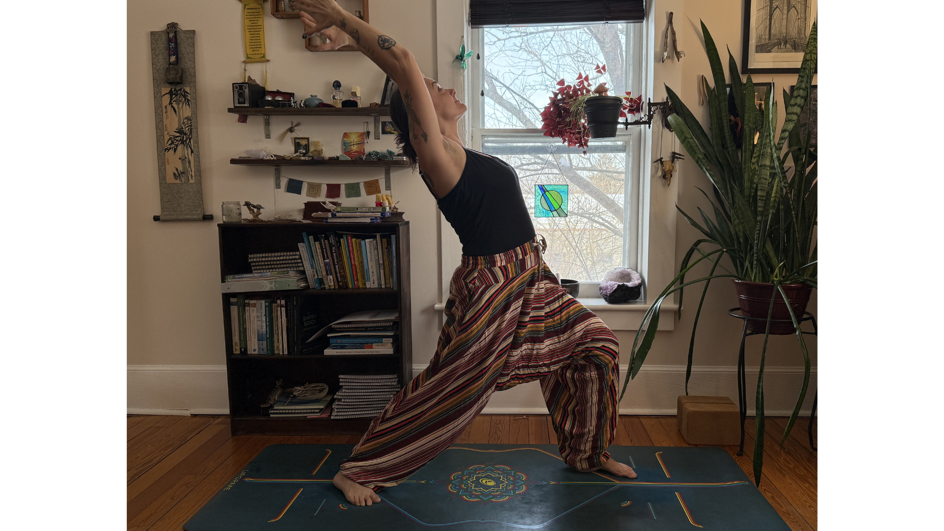 Woman standing on a mat in a version of Reverse Warrior