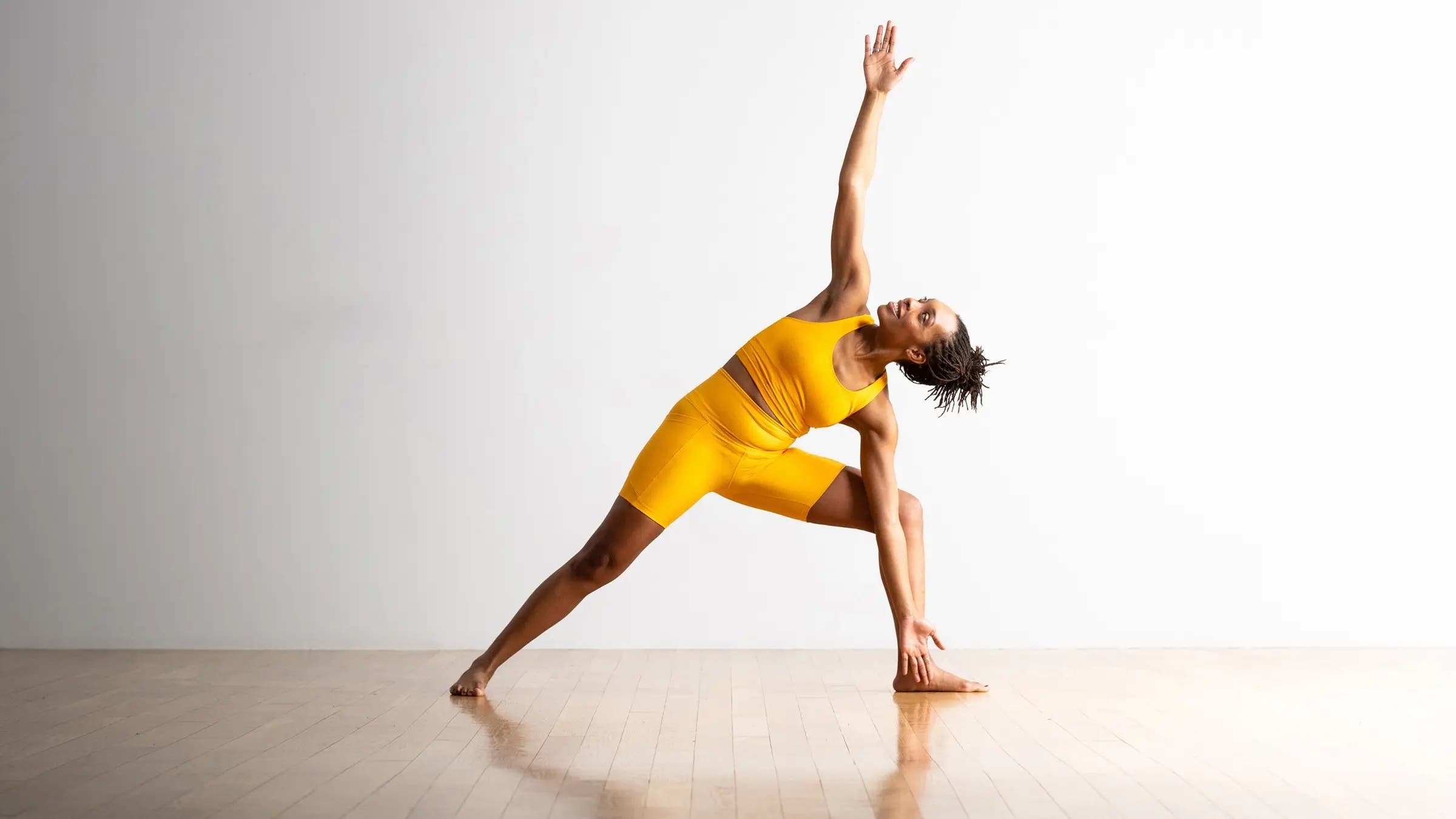 A woman lying in Extended Side Angle Pose, one of our favorite yoga pose for anxiety
