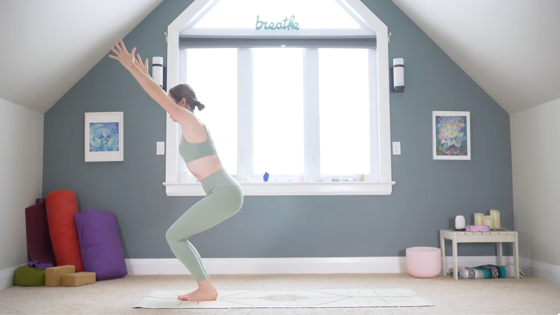Woman in Chair Pose with her knees bent and her arms reaching overhead during a 10-minute morning yoga practice