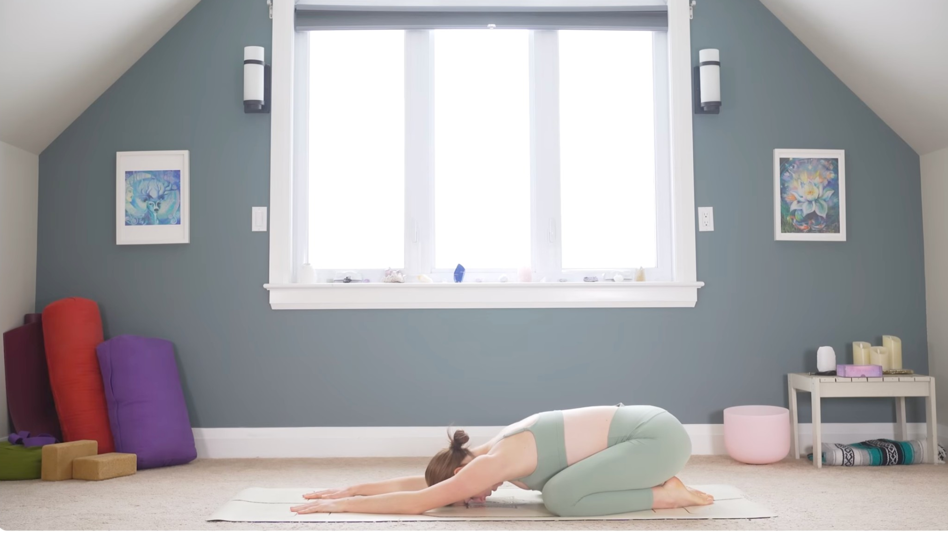 Woman kneeling on a mat in Child's Pose