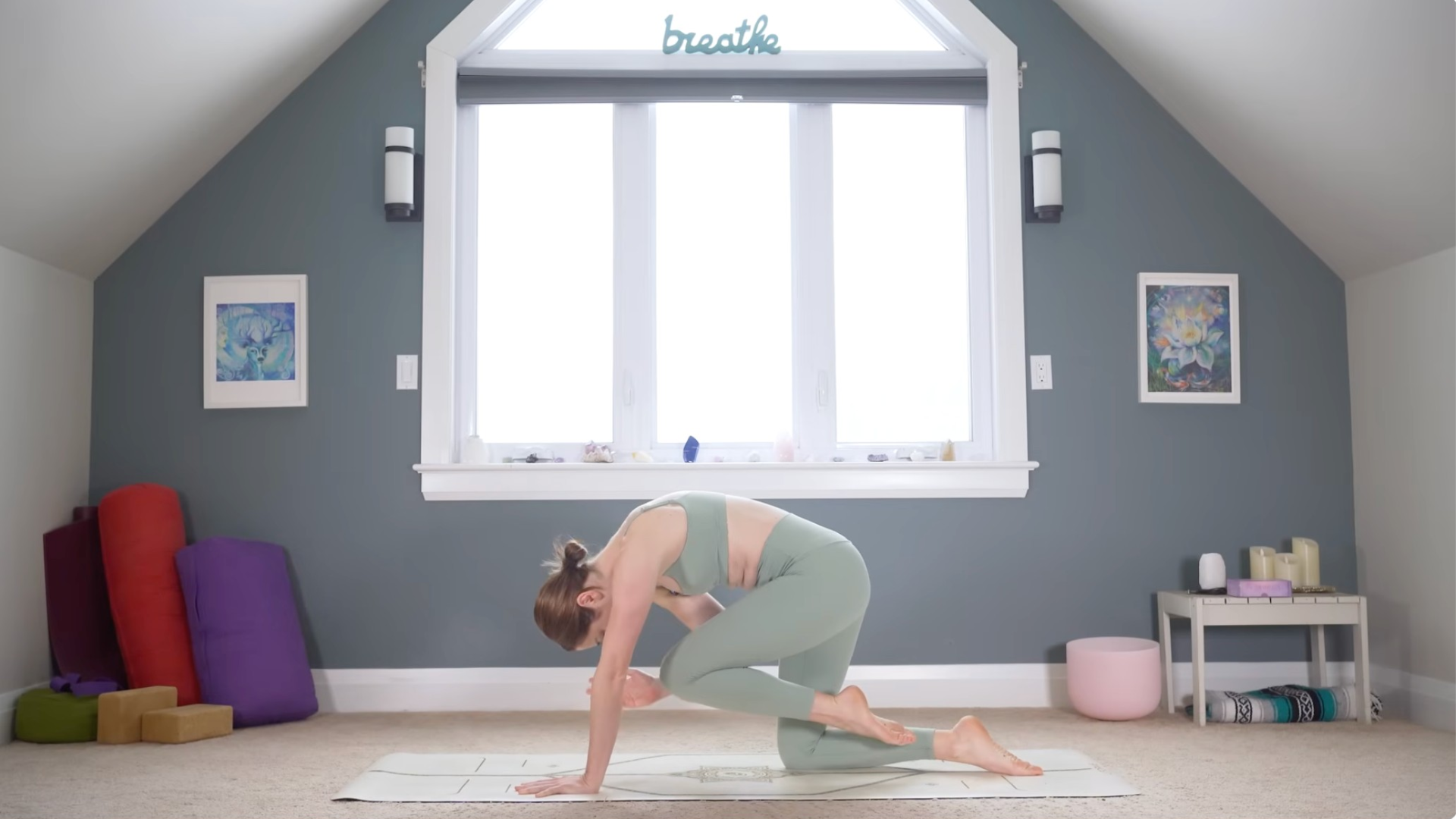 Woman kneeling on a mat drawing her left knee and right elbow together beneath her chest