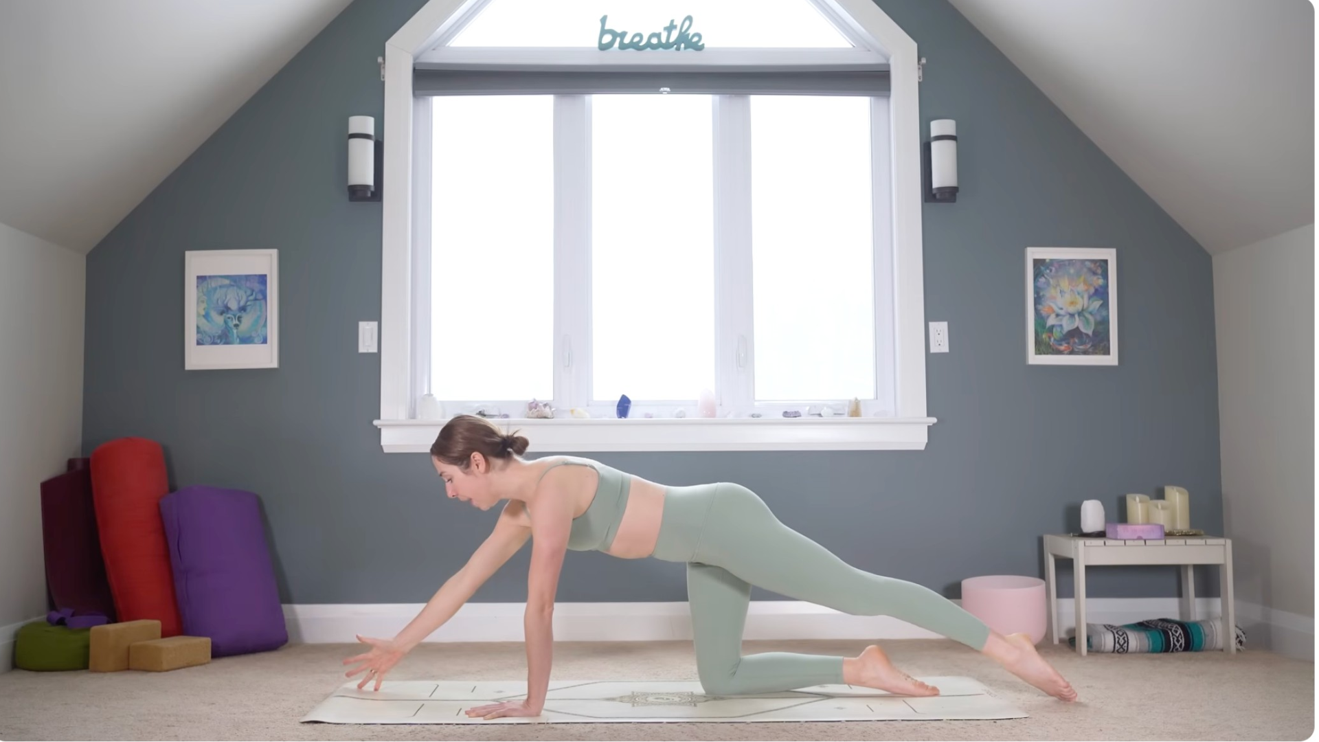 Woman on a mat in a variation of Bird Dog