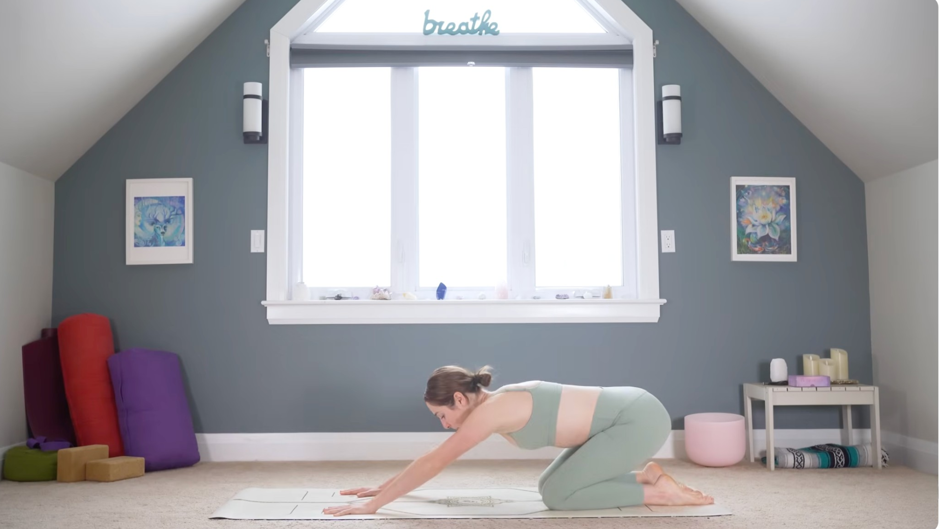 Woman leaning her hips back over her heels while keeping her hands and knees on the mat