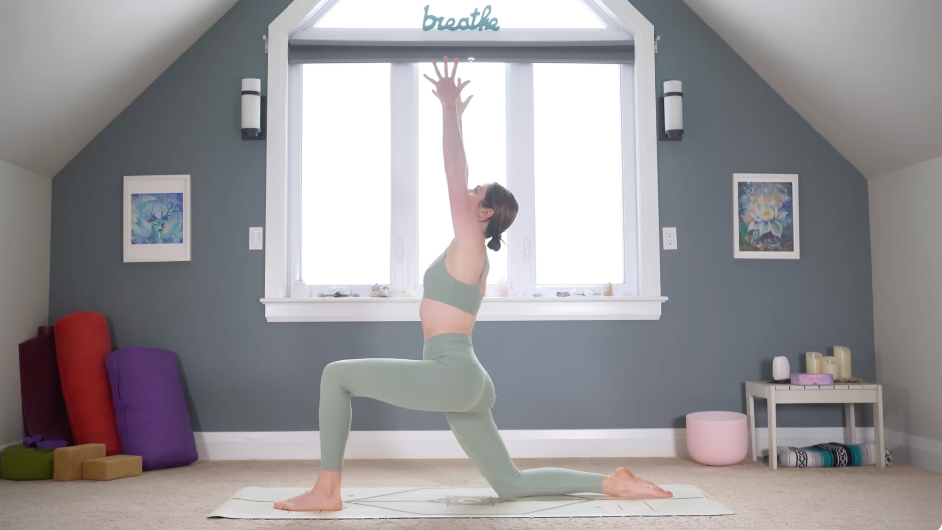 Woman kneeling on a mat reaching her arms overhead in Low Lunge during a 10-minute morning yoga routine