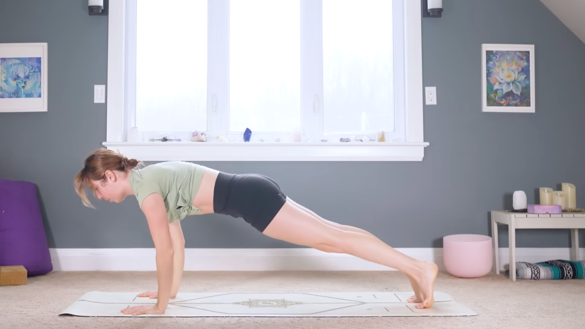 Woman in the top of a push-up or Plank Pose on a mat