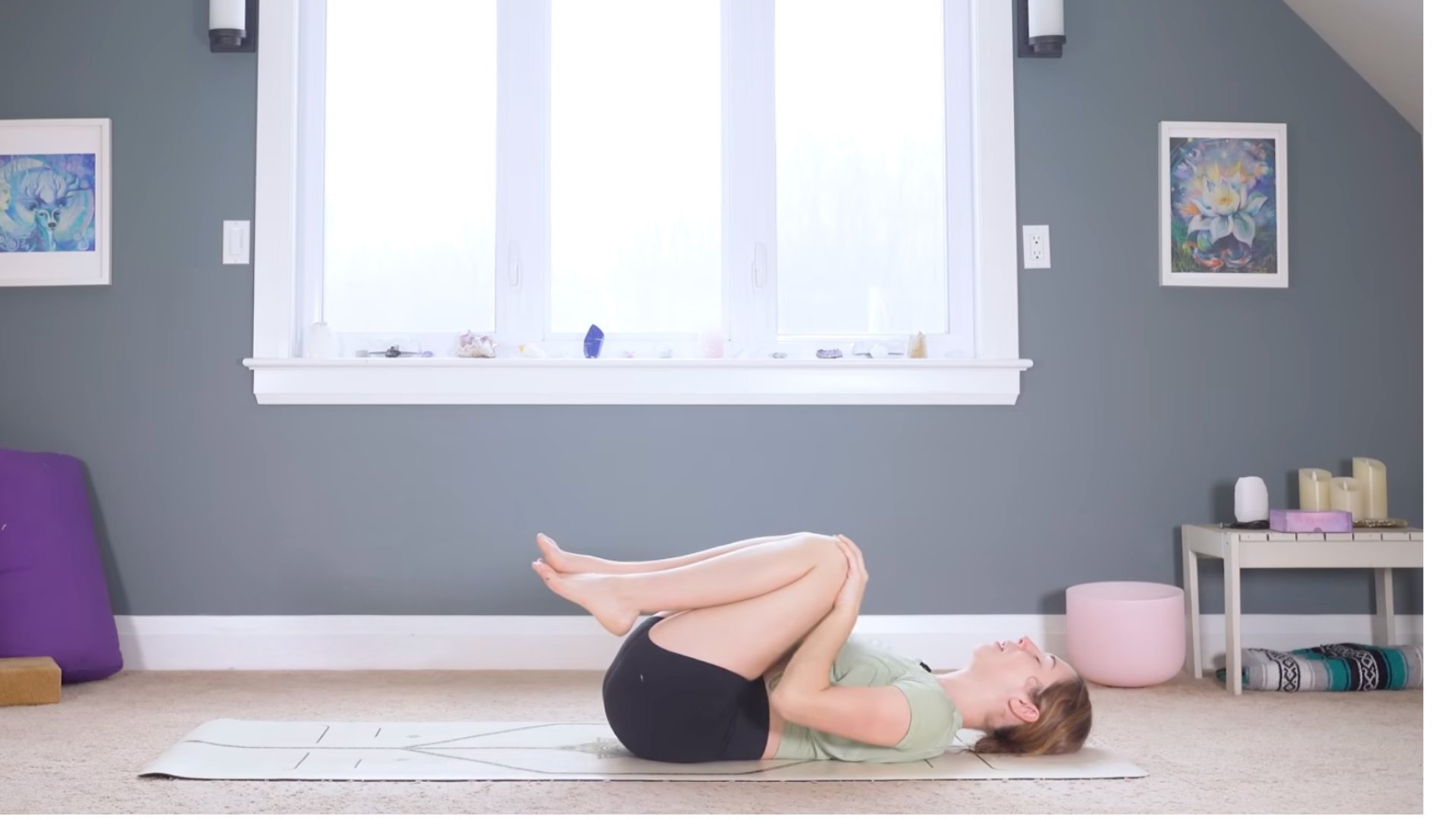 Woman lying on her back with her knees drawn toward her chest