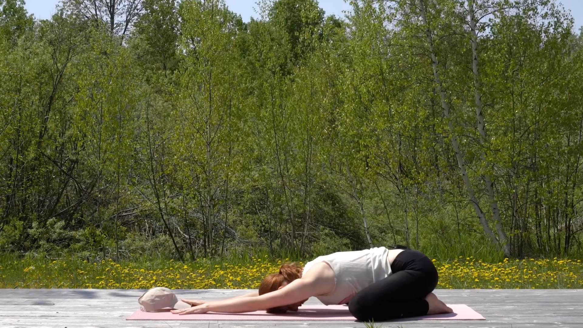 Woman in Child's Pose on a yoga mat during a 10-minute morning yoga routine
