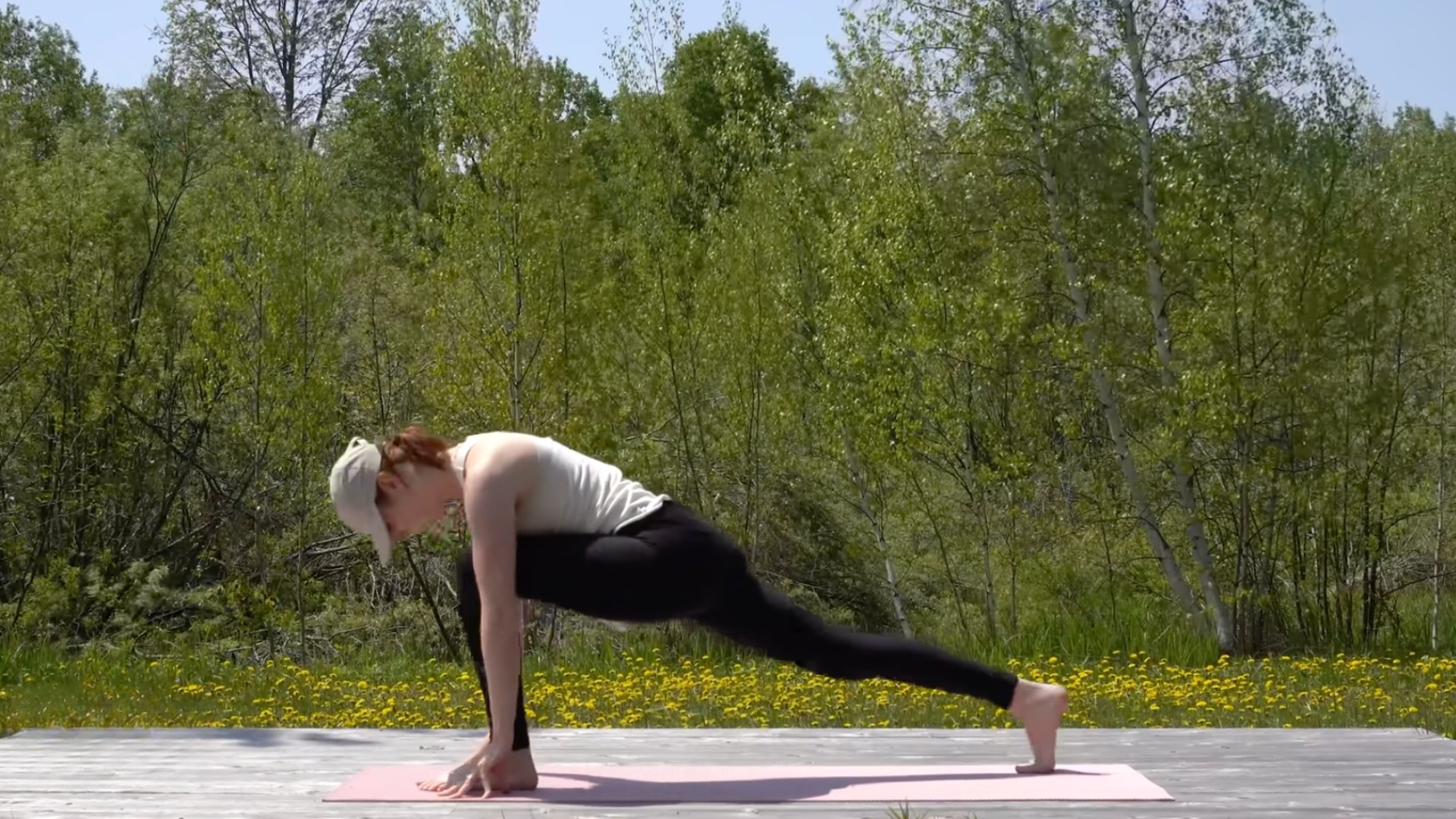 Woman in a lunge on a mat with her left knee bent and her right leg straight behind her