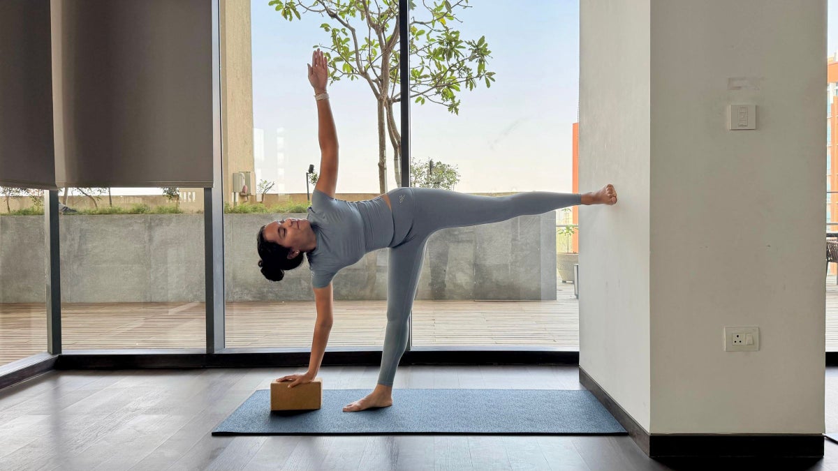 6 Unexpected Ways to Use a Wall in Yoga to Stretch and Strengthen