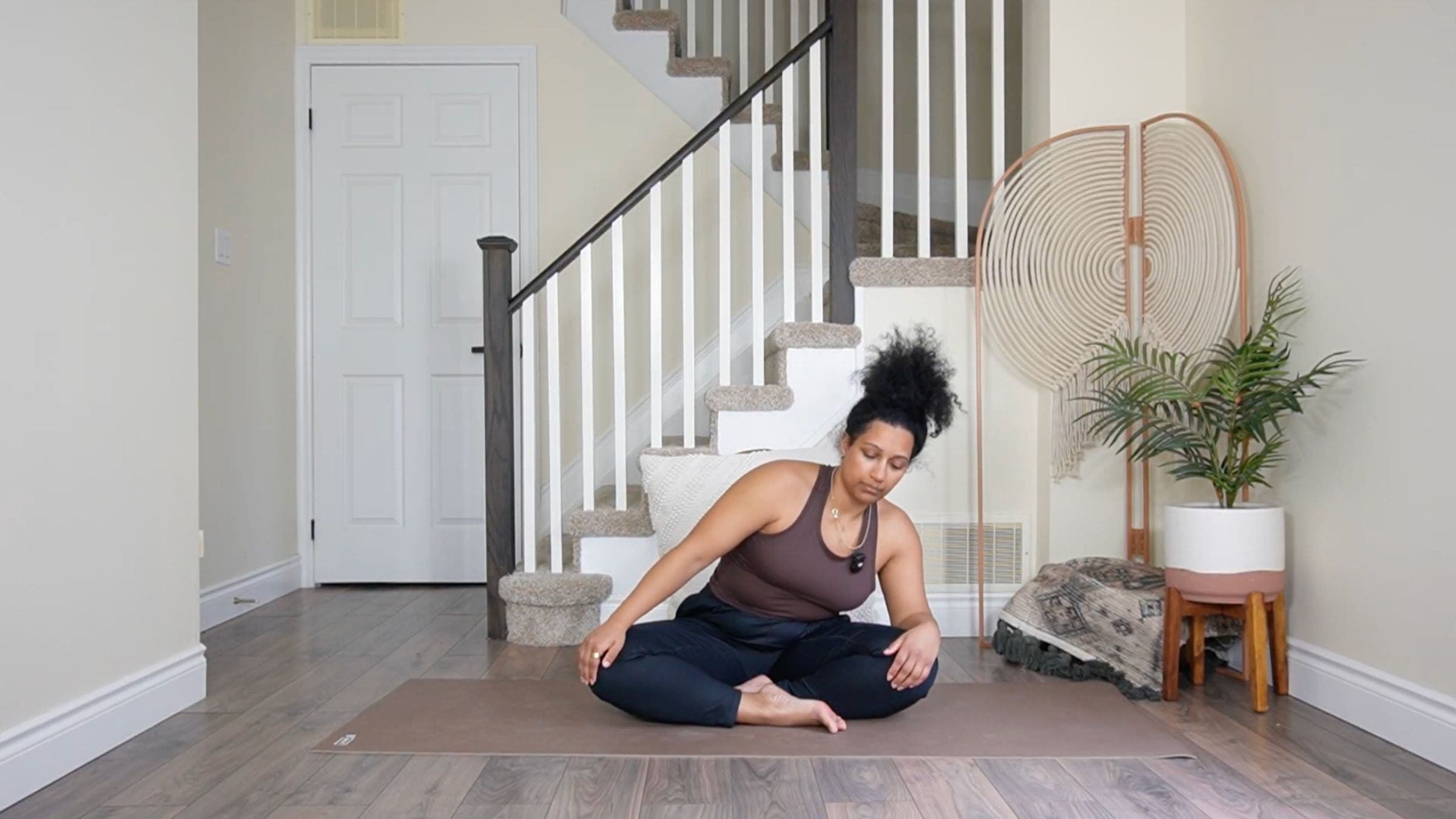 Yoga teacher practicing torso circles.
