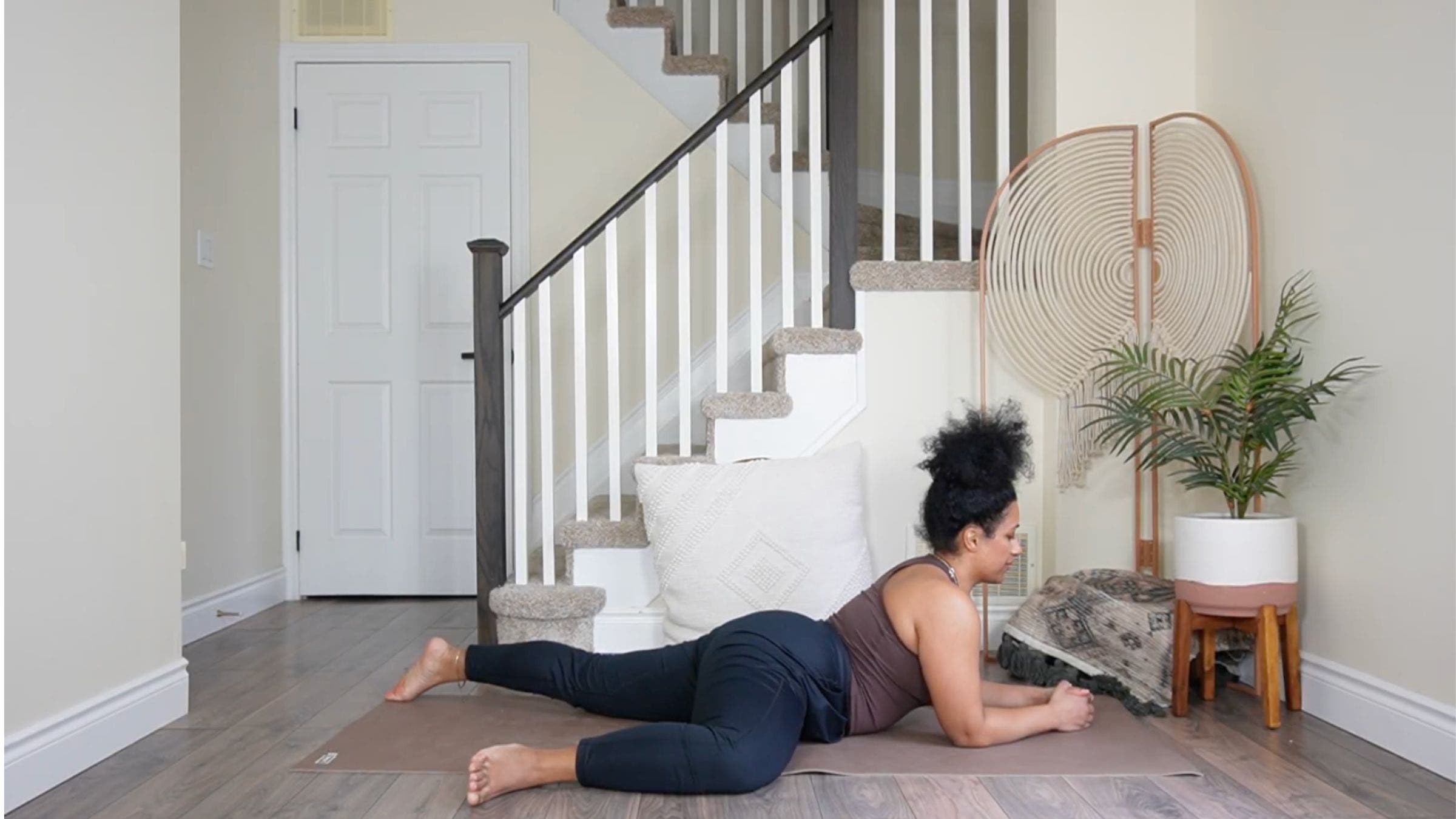 Yoga teacher practicing Half Frog Pose.