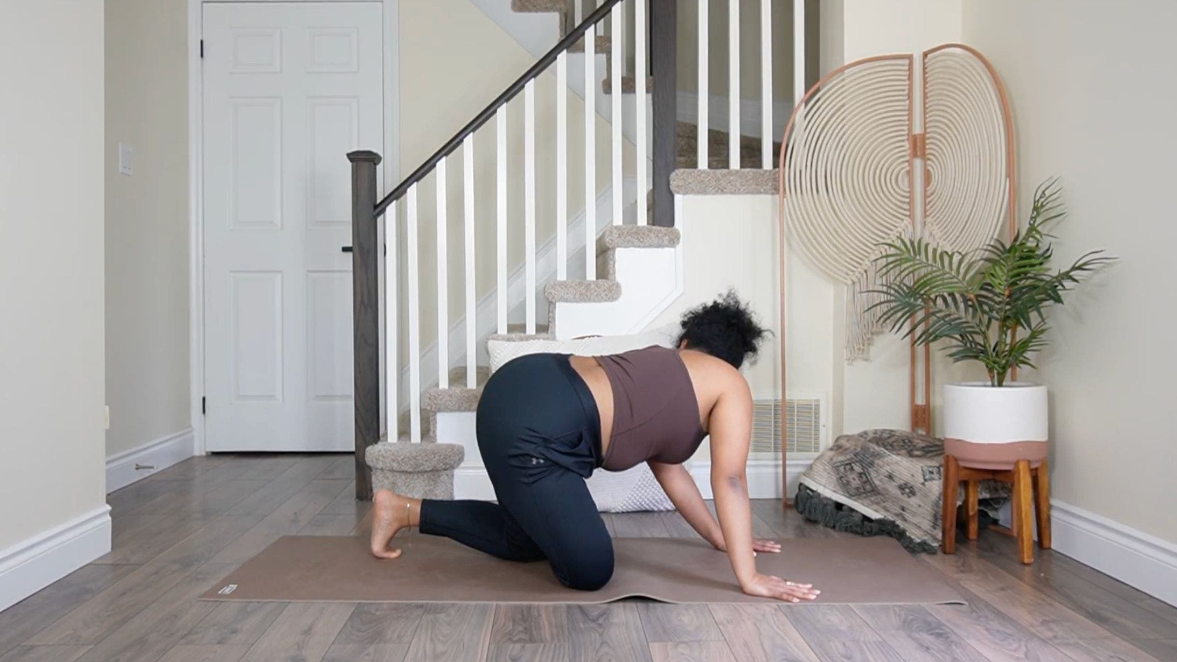 Yoga teacher practicing Figure 4 stretch.