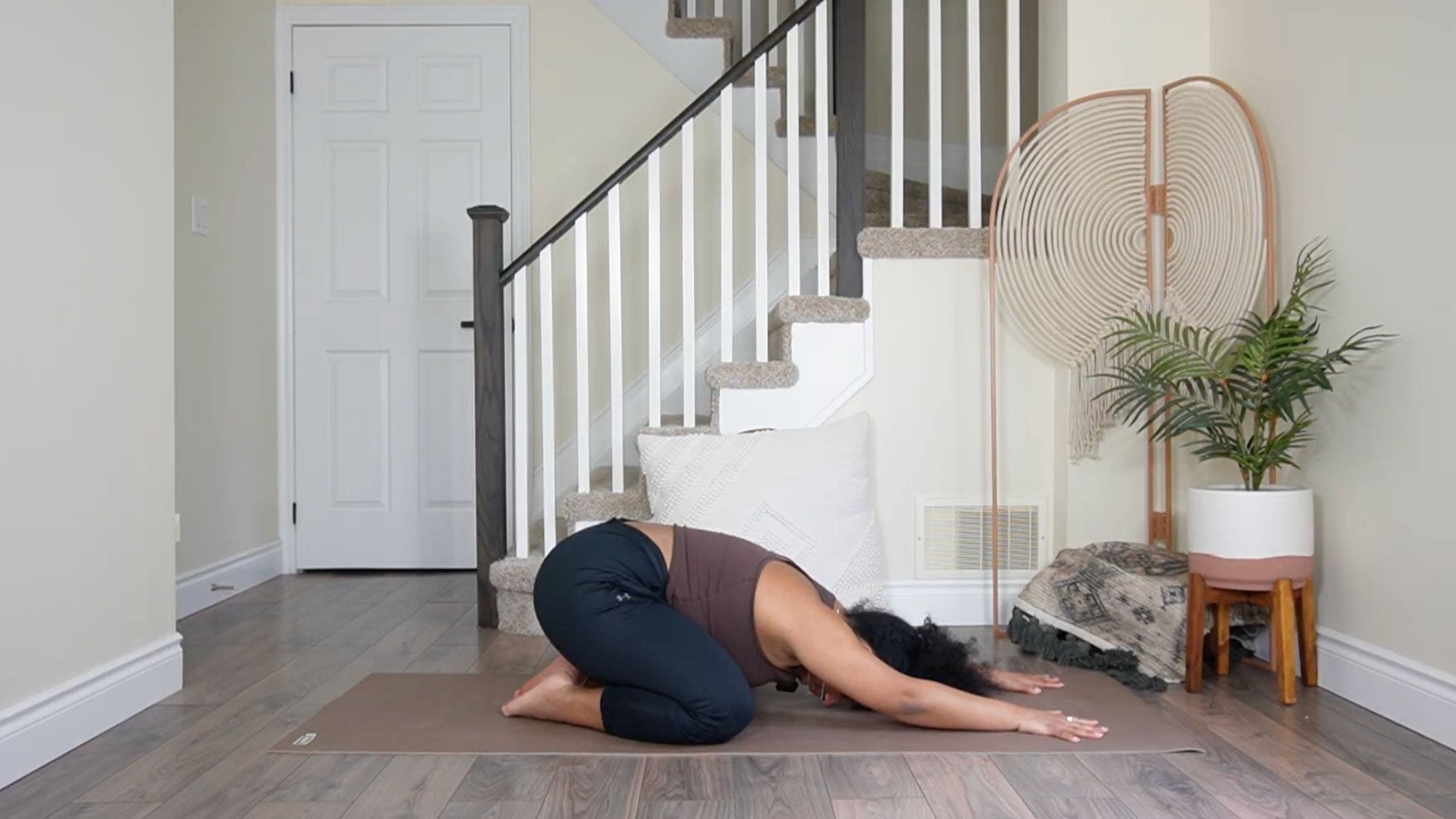 Yoga teacher practicing Child's Pose.