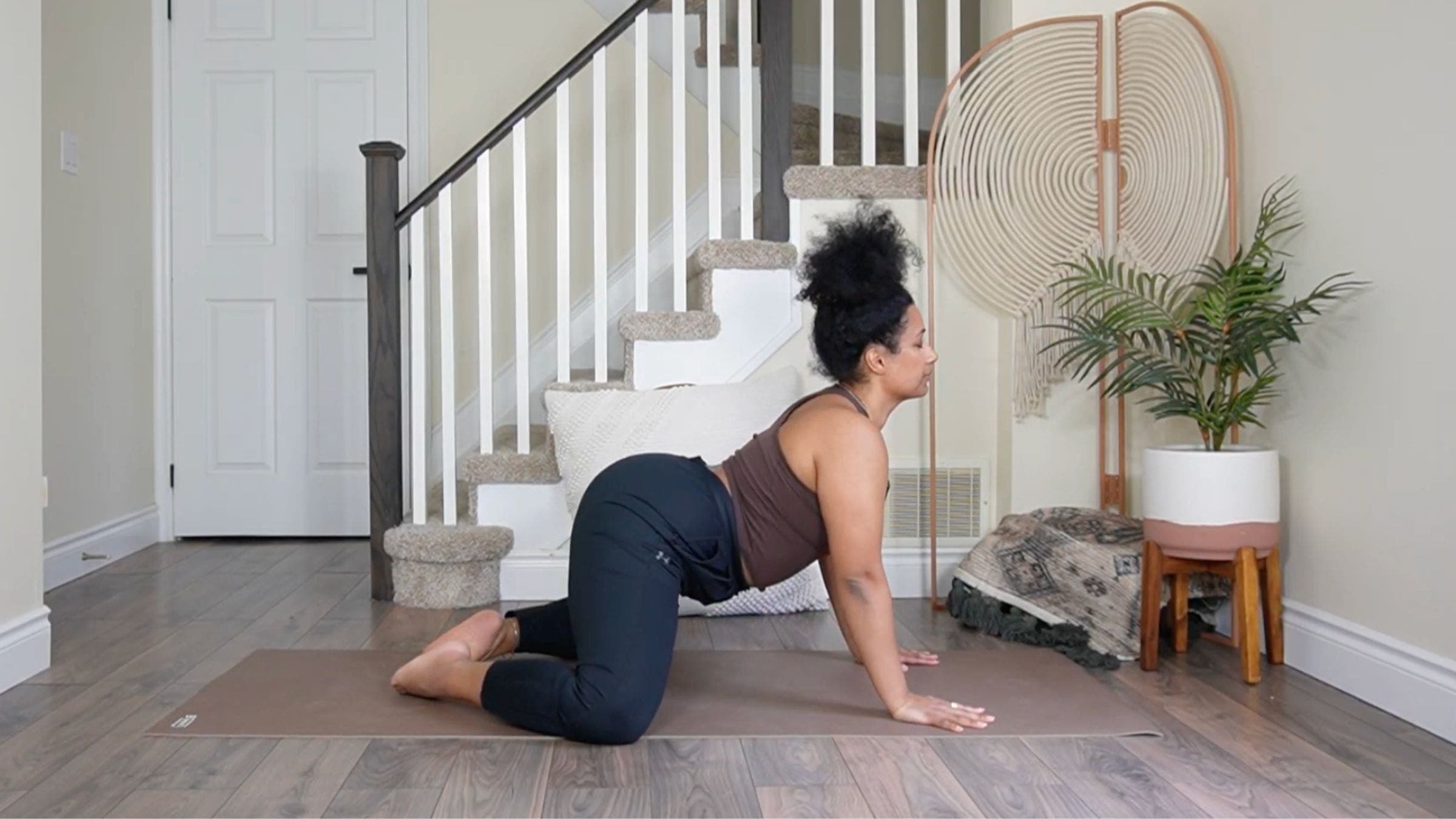 Yoga teacher practicing Cow Pose.