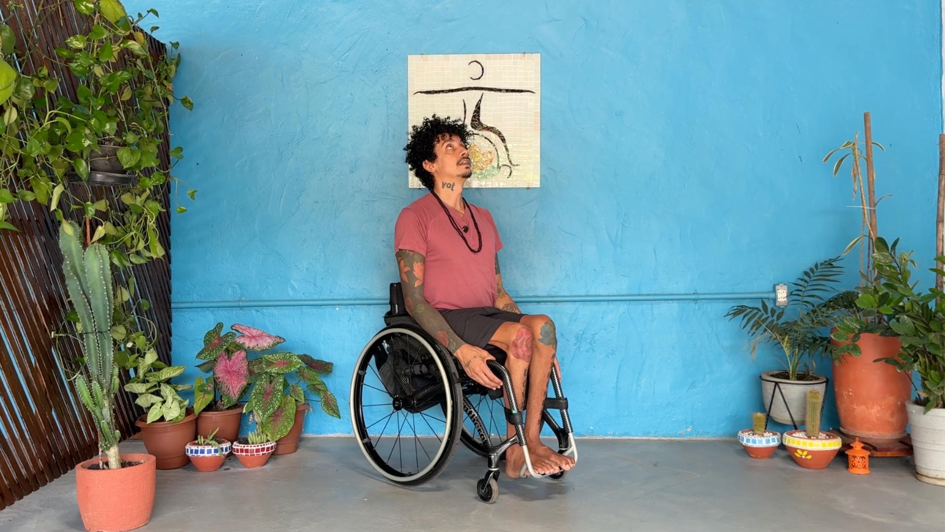 Adaptive and accessible yoga teacher demonstrating Cobra Pose