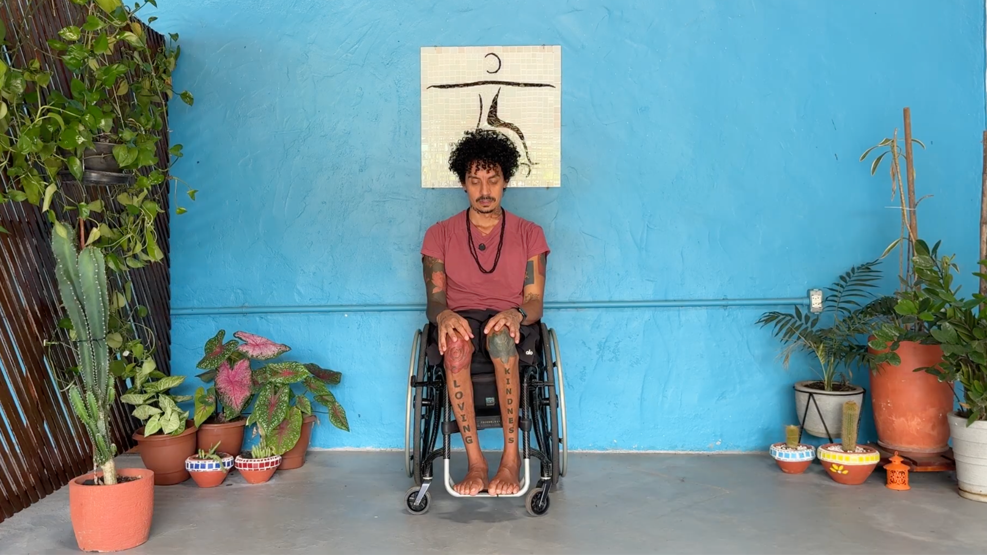Man sitting in a wheelchair practicing neck stretches
