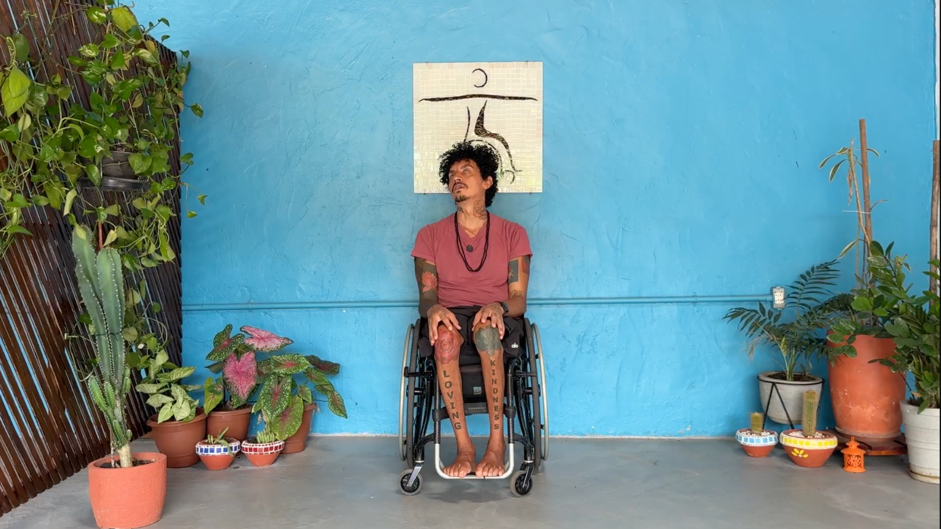 Man sitting in a wheelchair practicing neck circles during a chair yoga for challenge practice