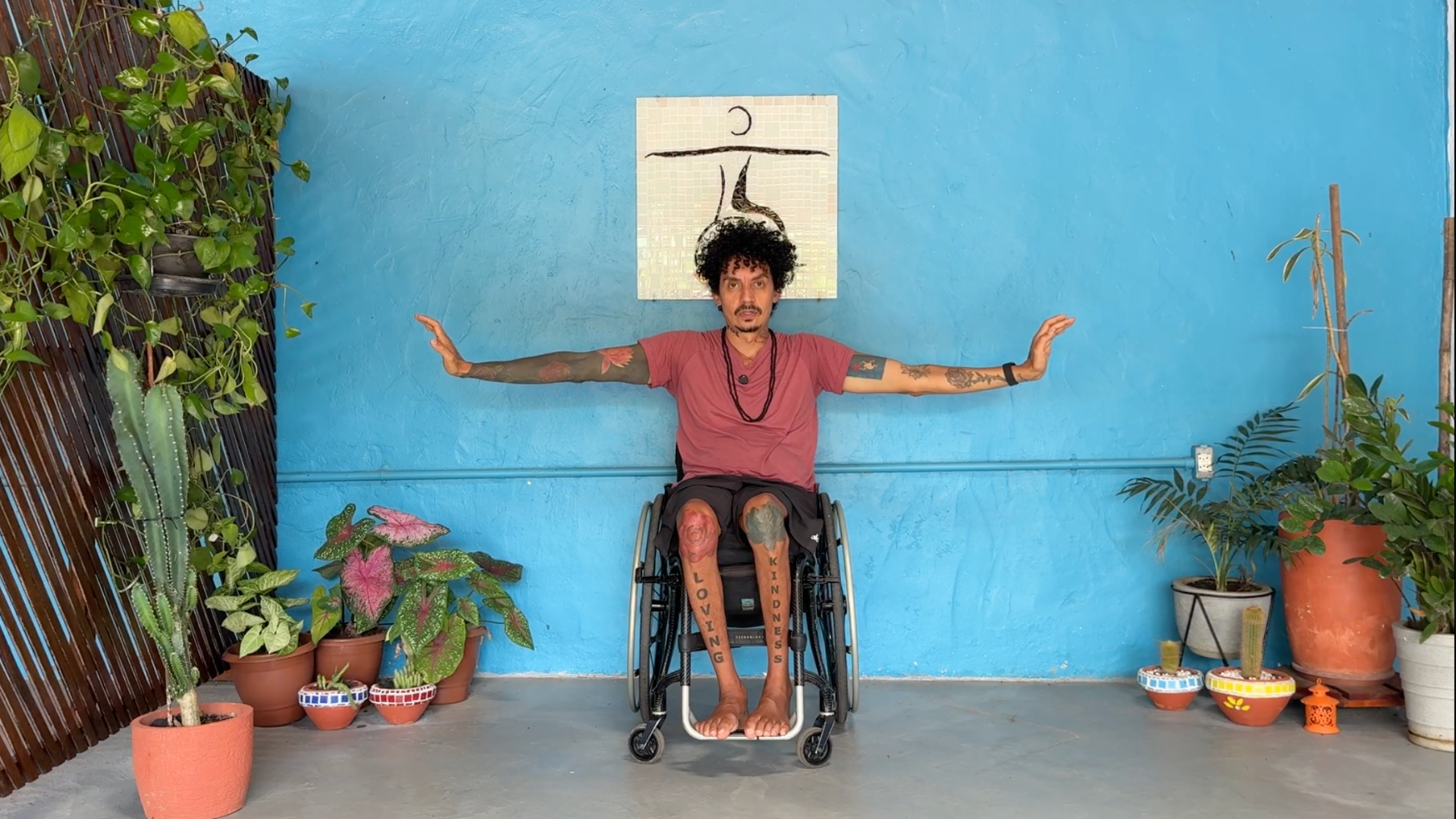 Man sitting in a wheelchair practicing arm-strengthening exercises