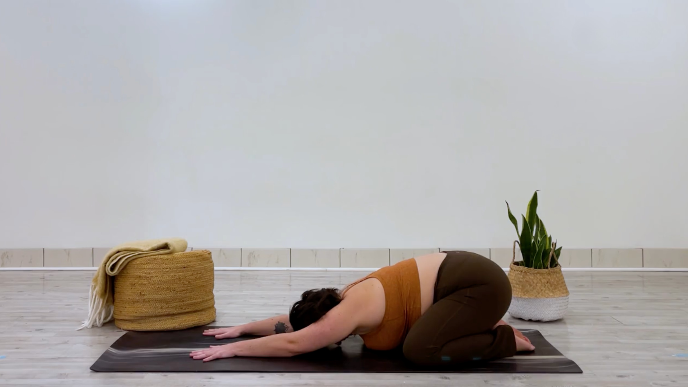 Yoga teacher Taylor Lorenz in Child's Pose, part of her good mood yoga practice