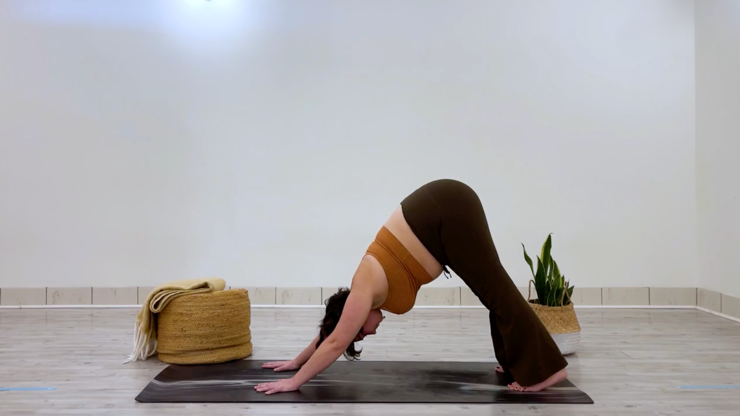 Teacher Taylor Lorenz in Downward-Facing Dog Pose