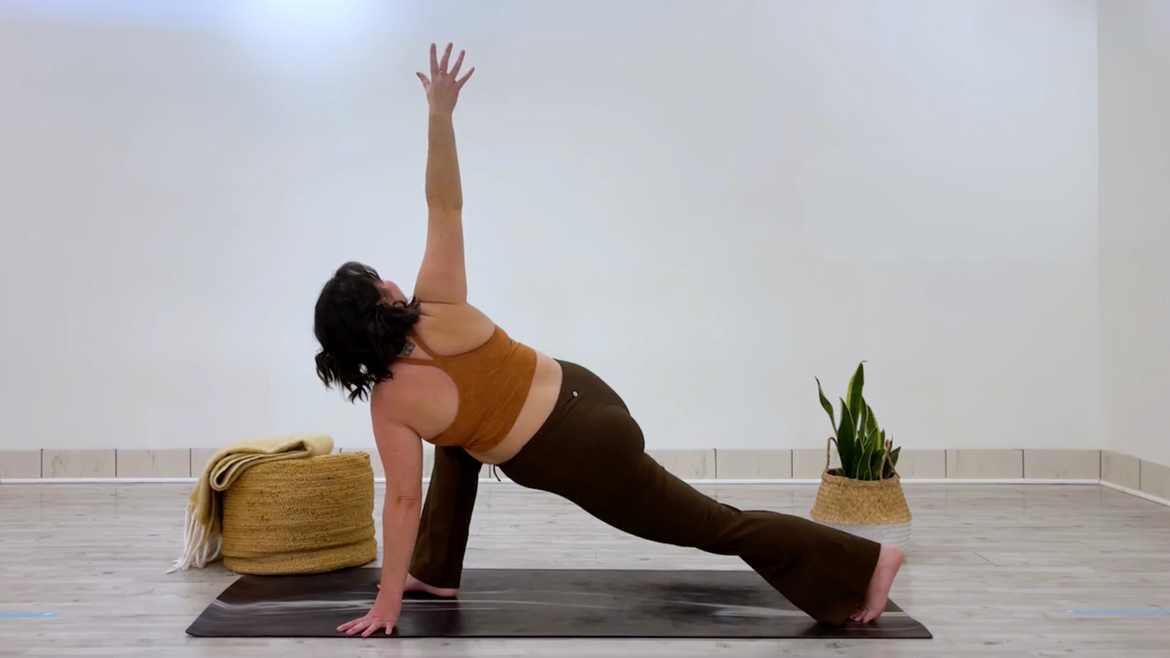 Yoga teacher Taylor Lorenz in Revolved High Lunge, part of her good mood yoga practice