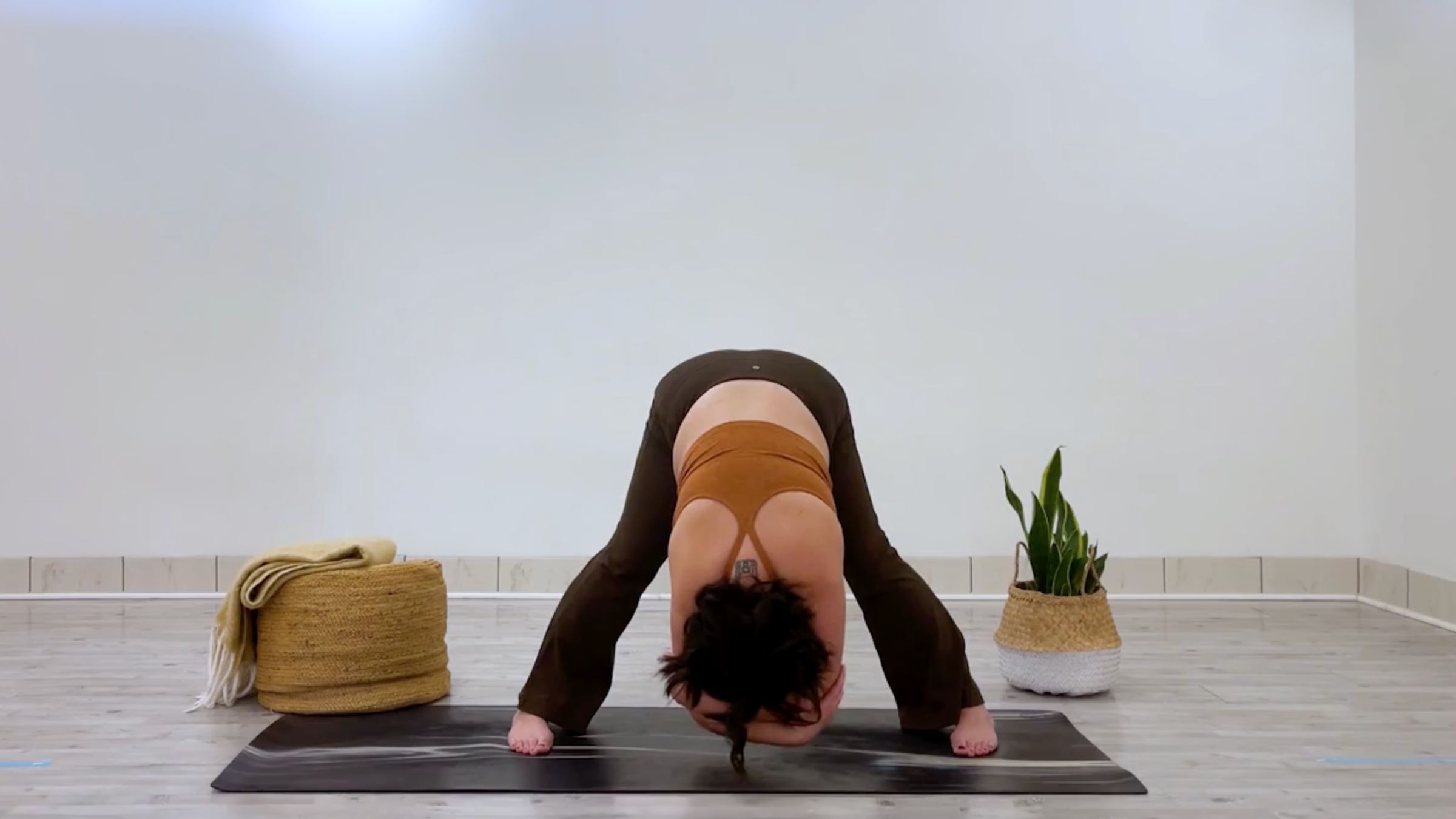 Yoga teacher Taylor Lorenz in Wide-Legged Forward Bend, part of her good mood yoga practice