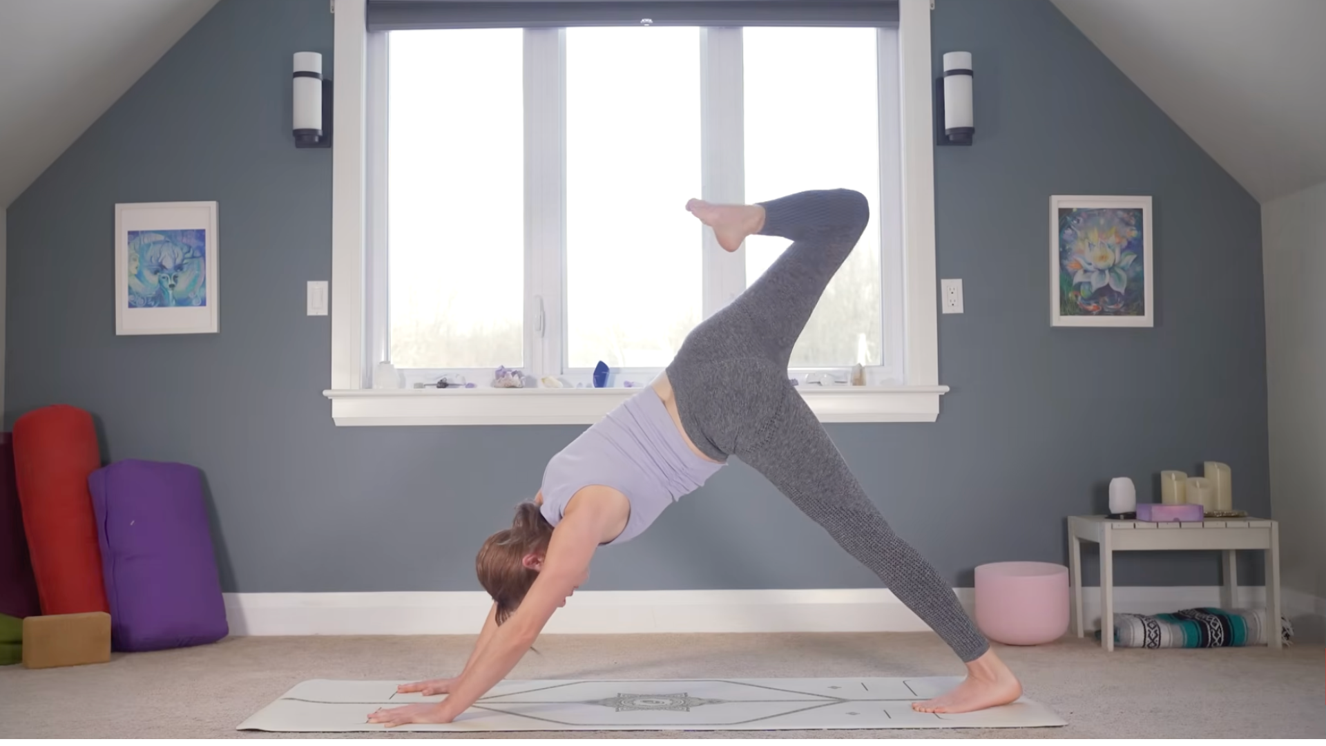 Woman standing on a yoga mat with her right knee bent
