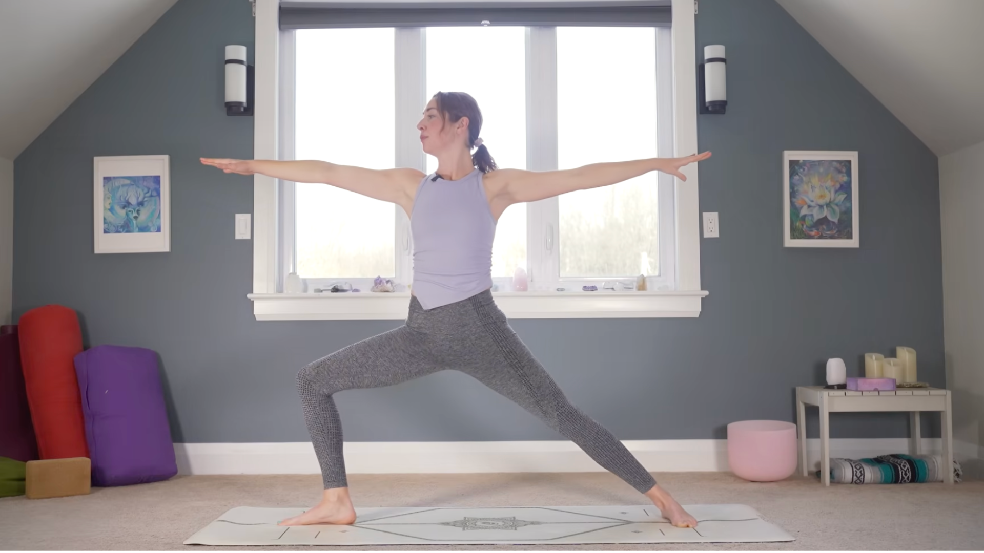 Woman standing on a mat in Warrior 2