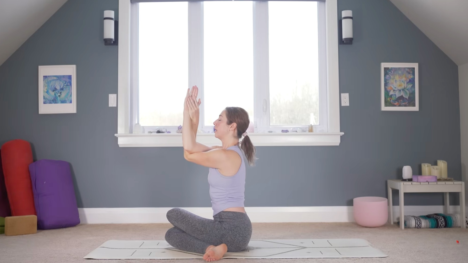 Woman sitting with her arms and legs crossed in Cow-Face Pose
