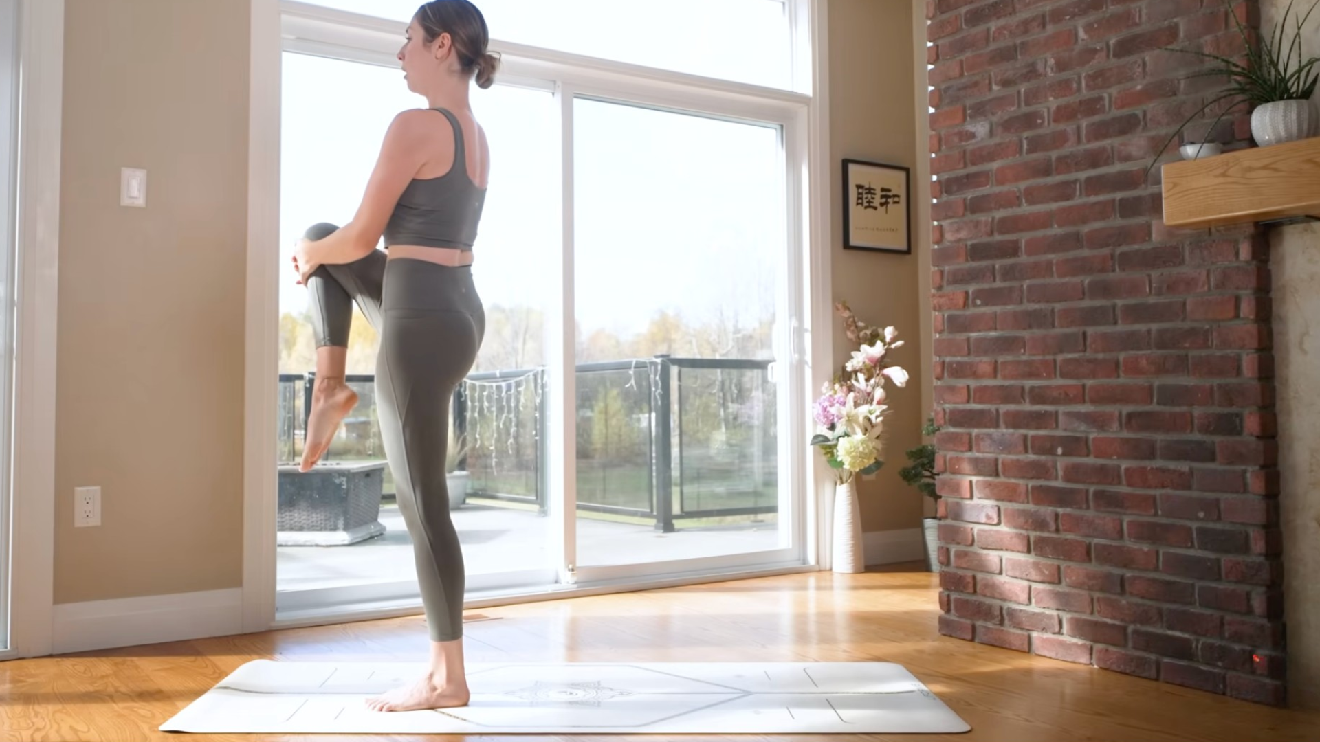 Woman lifting her right knee toward her chest as she looks straight ahead