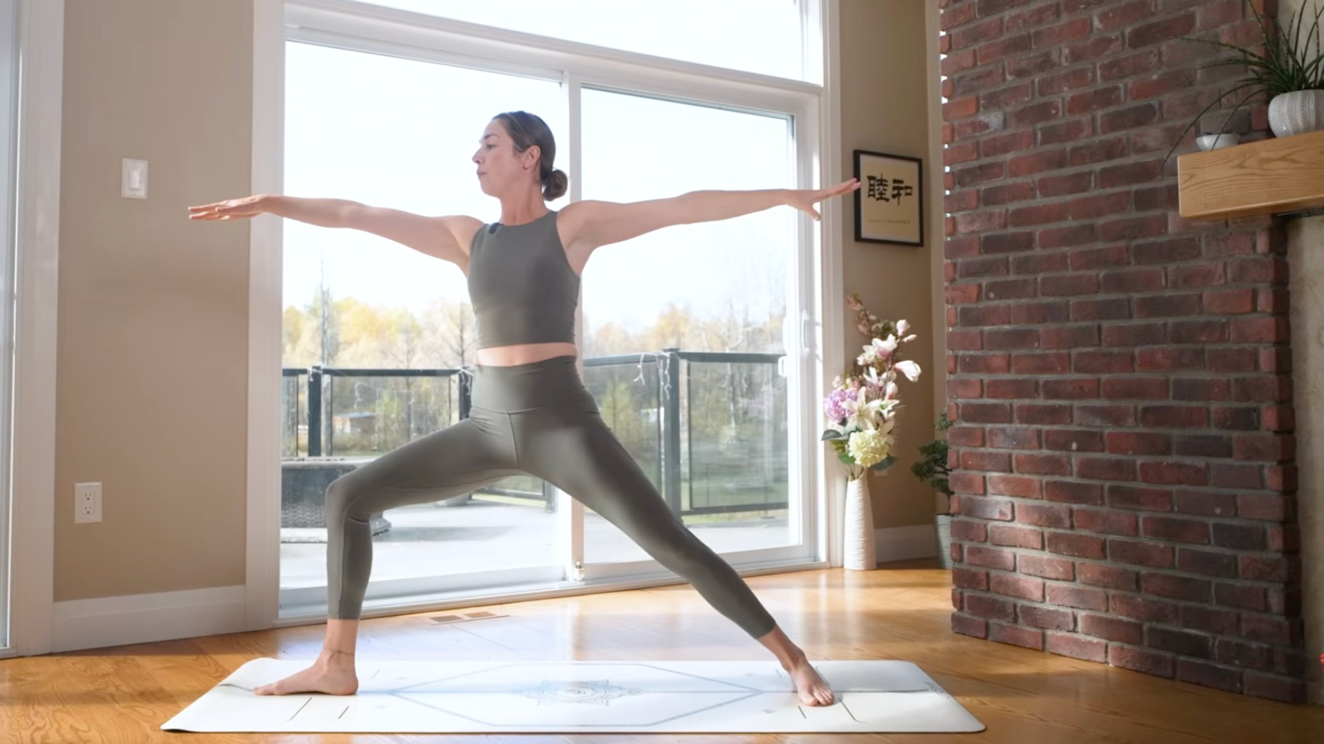Woman in Warrior 2 Pose with her arms extended straight and her front knee bent