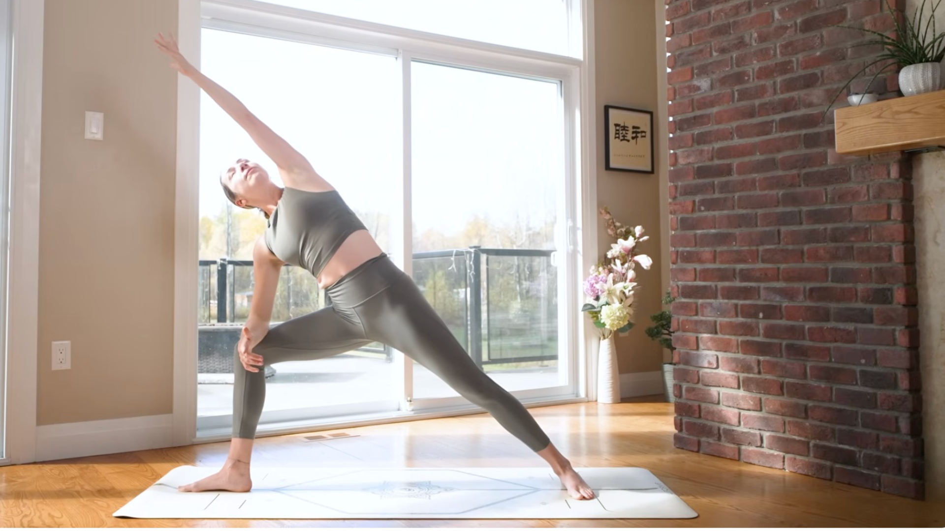 Woman in Extended Side Angle and reaching her left arm alongside her head