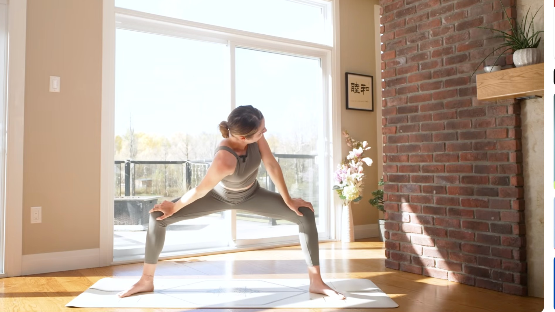 Woman with her hands on her thighs twisting her chest toward the left