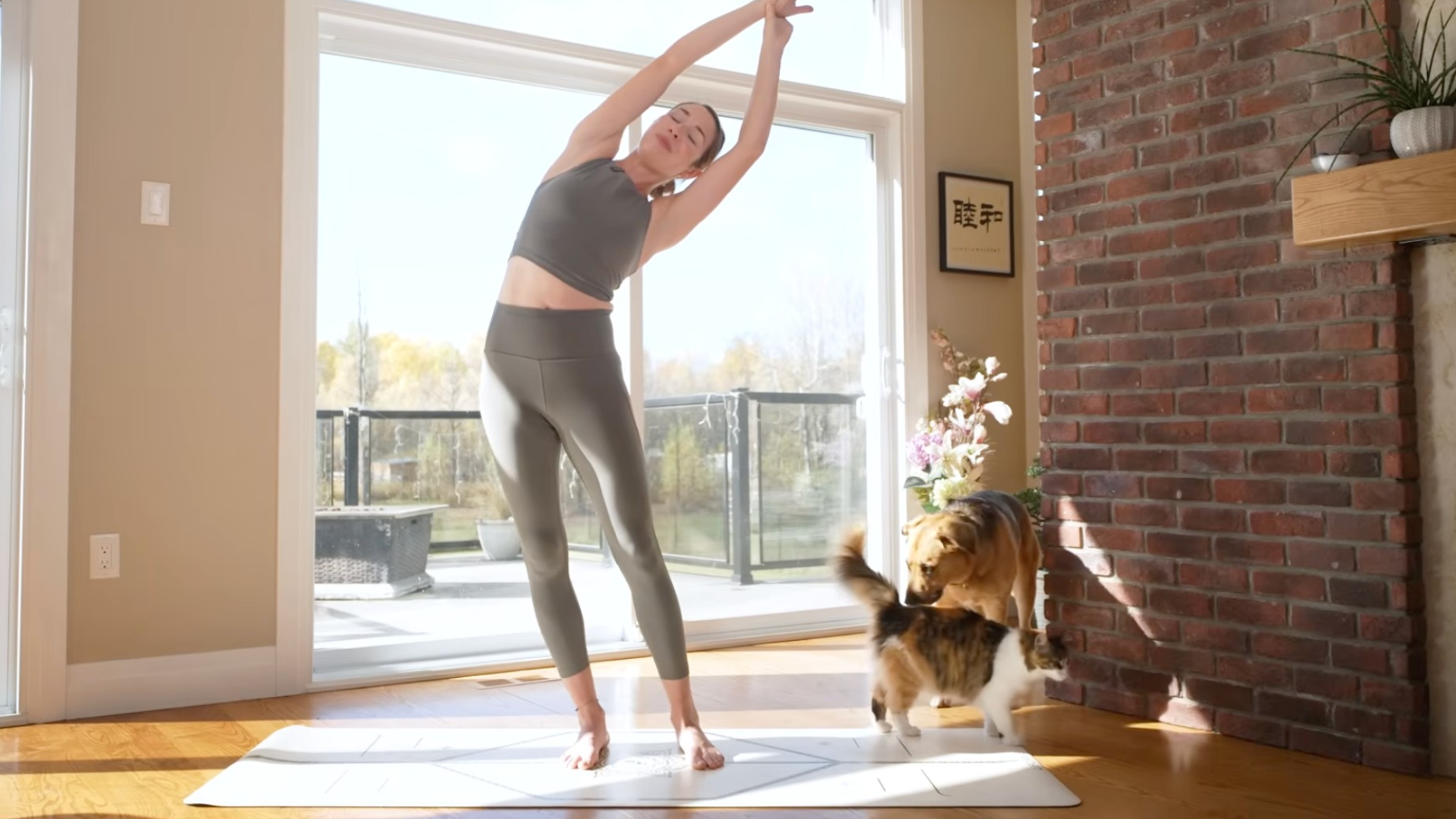 Woman in a side stretch while standing on a mat