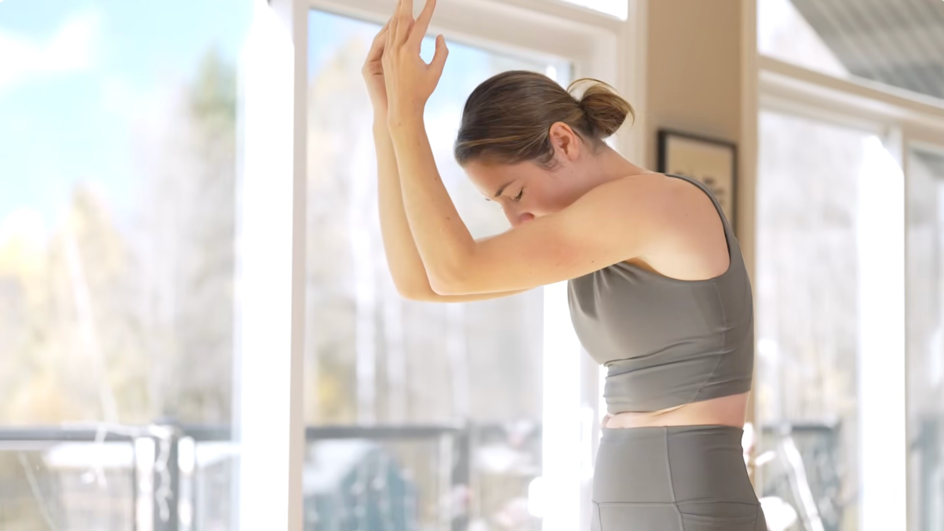 Woman rounding her chest and tucking her chin as she rounds her back