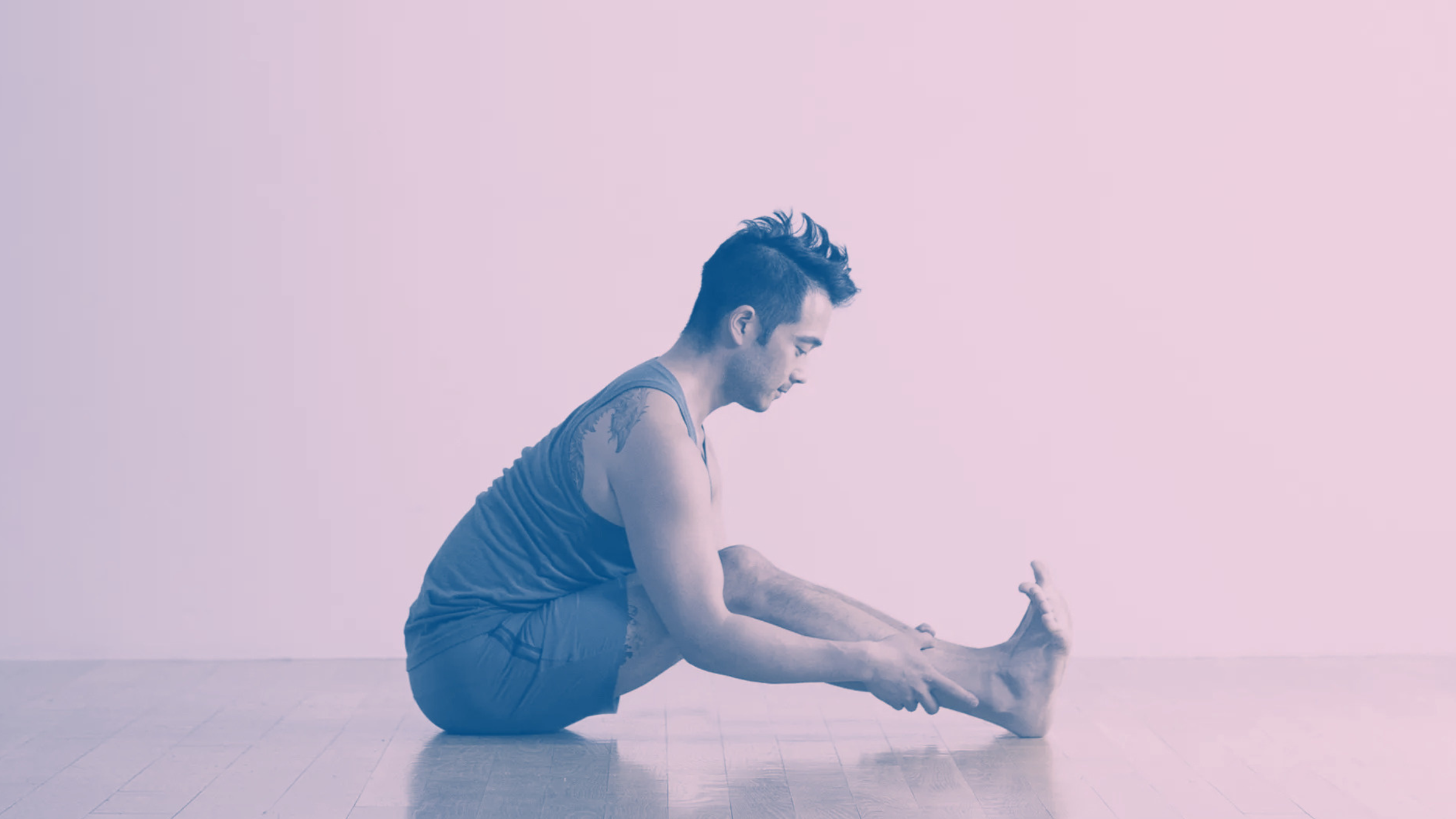 A man in Seated Forward Bend, a stretch for tight hamstrings