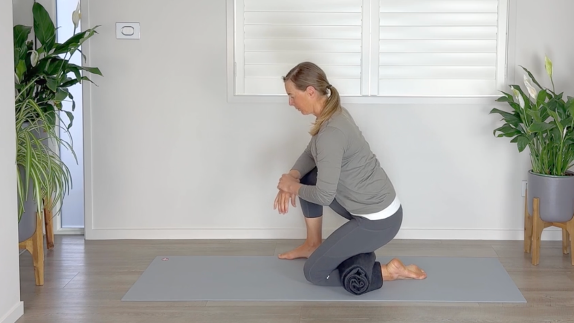 Woman kneels on one foot forward in Low Lunge version