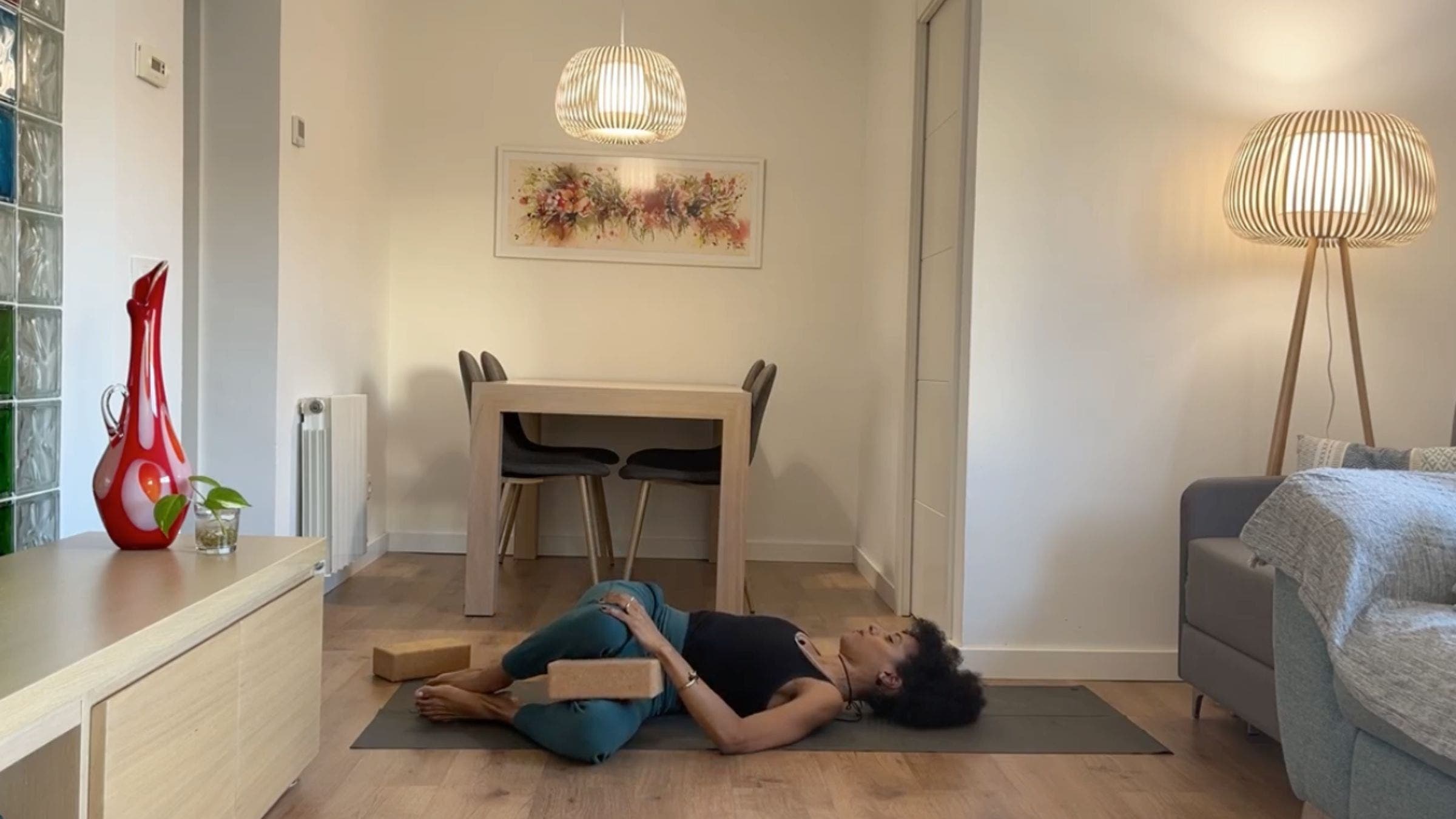 Yoga instructor practicing Supine Spinal Twist.