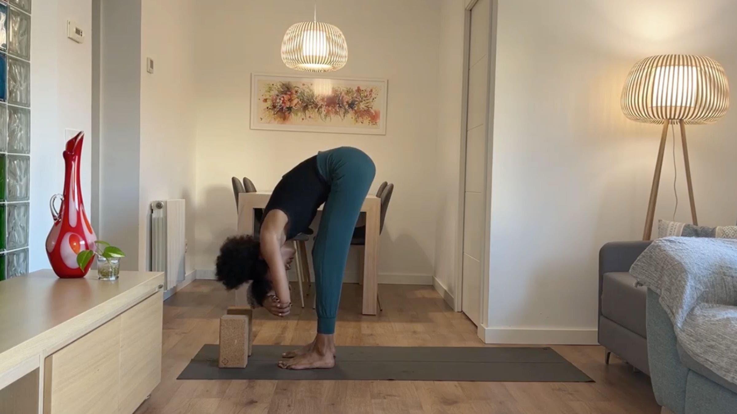 Yoga instructor practicing Standing Forward Bend.