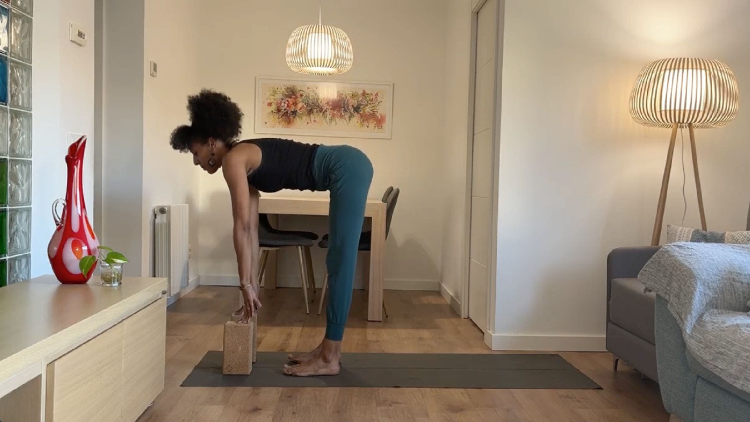 Yoga instructor practicing Half Standing Forward Bend.