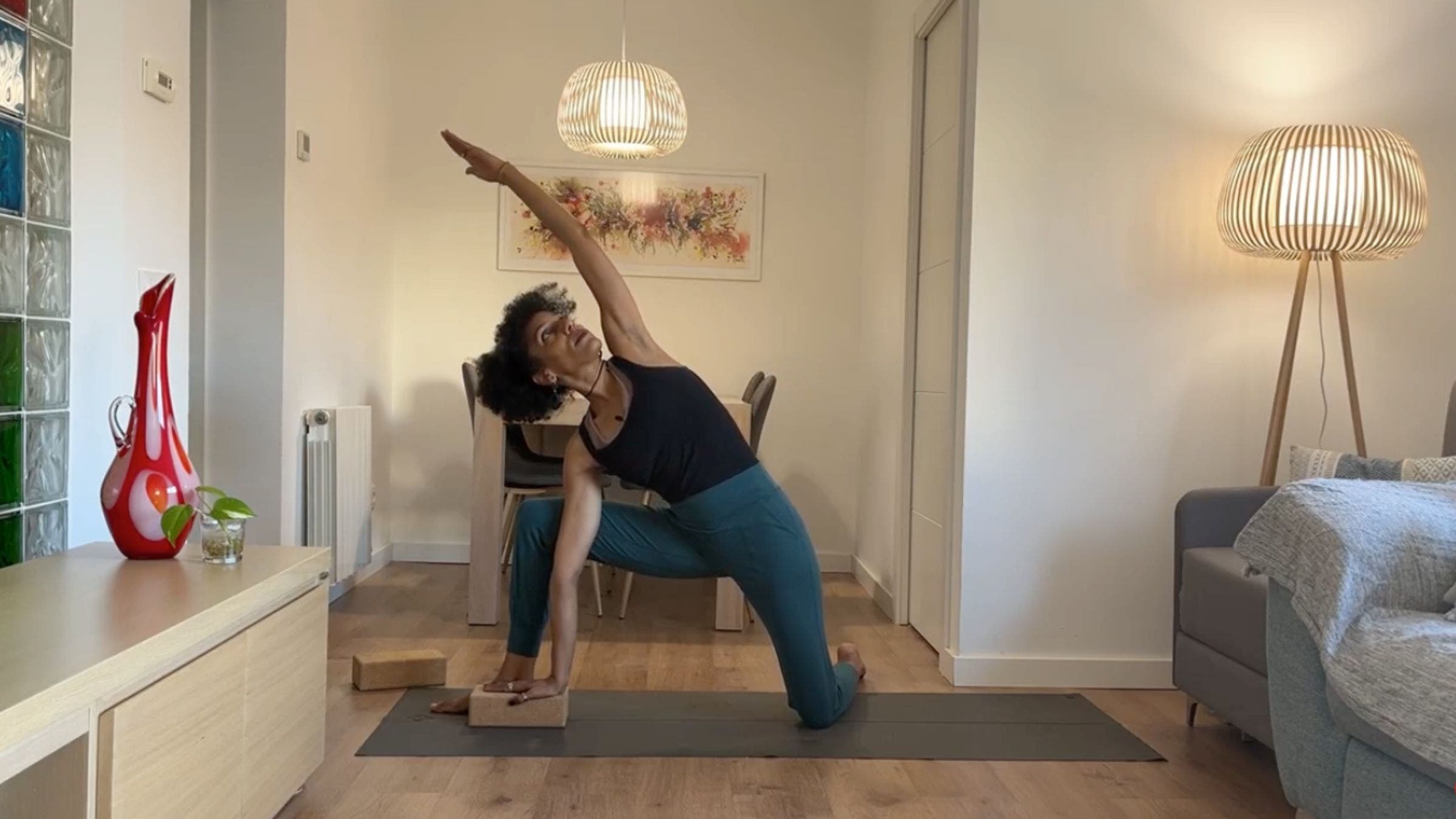 Yoga instructor practicing kneeling Side Angle Pose.