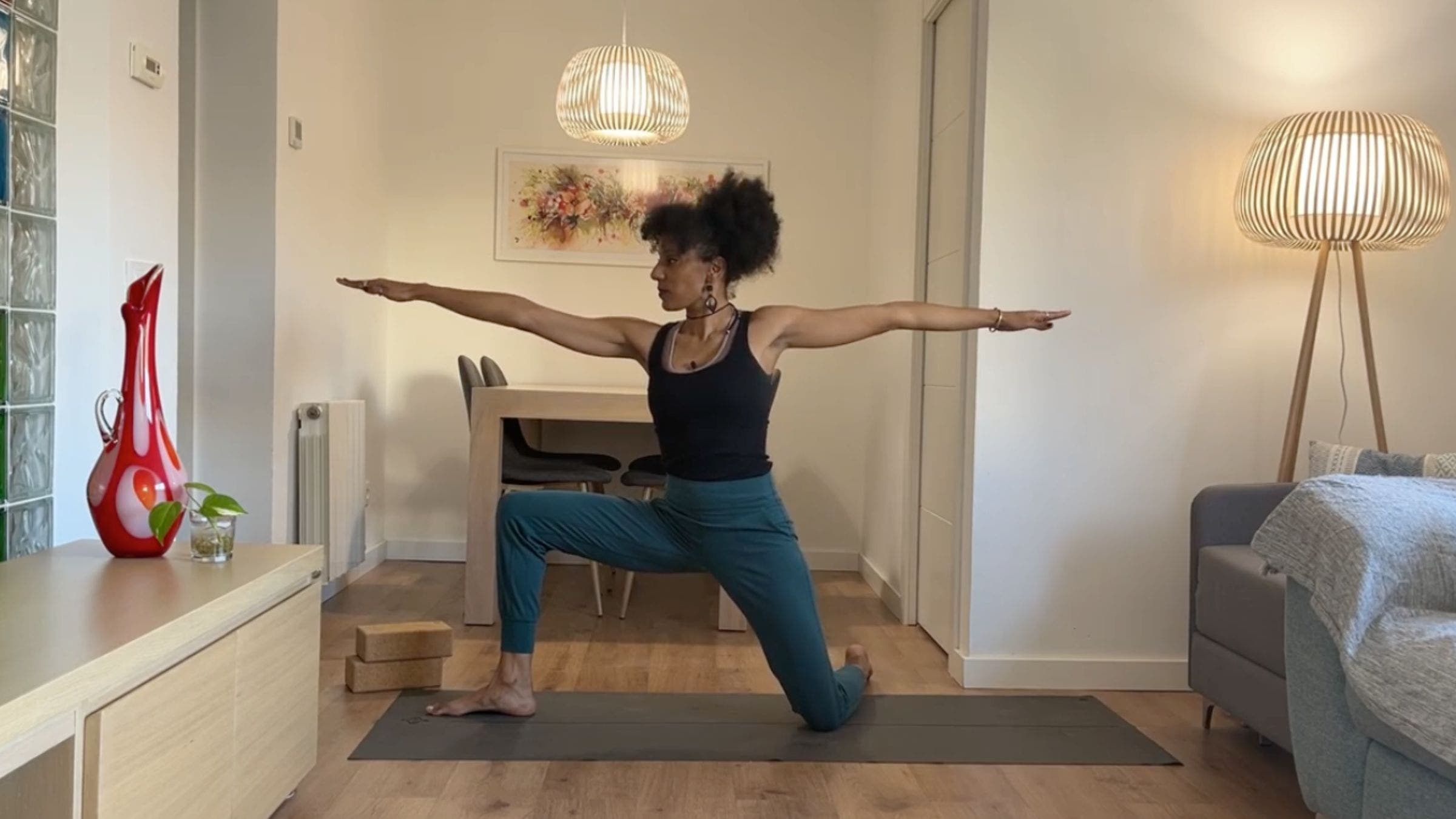 Yoga instructor practicing Kneeling Warrior 2.