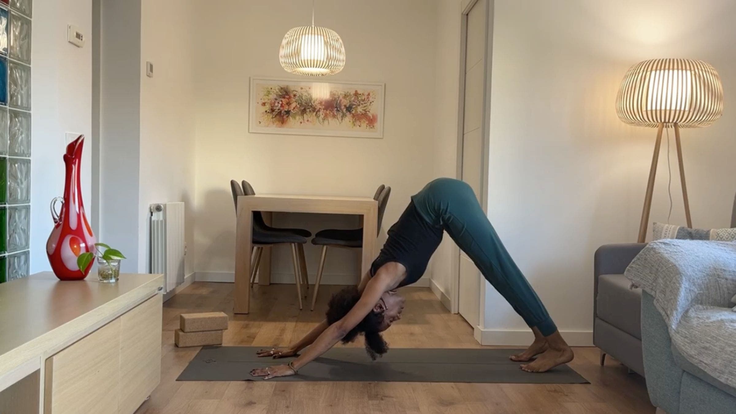 Yoga instructor practicing Downward Dog.