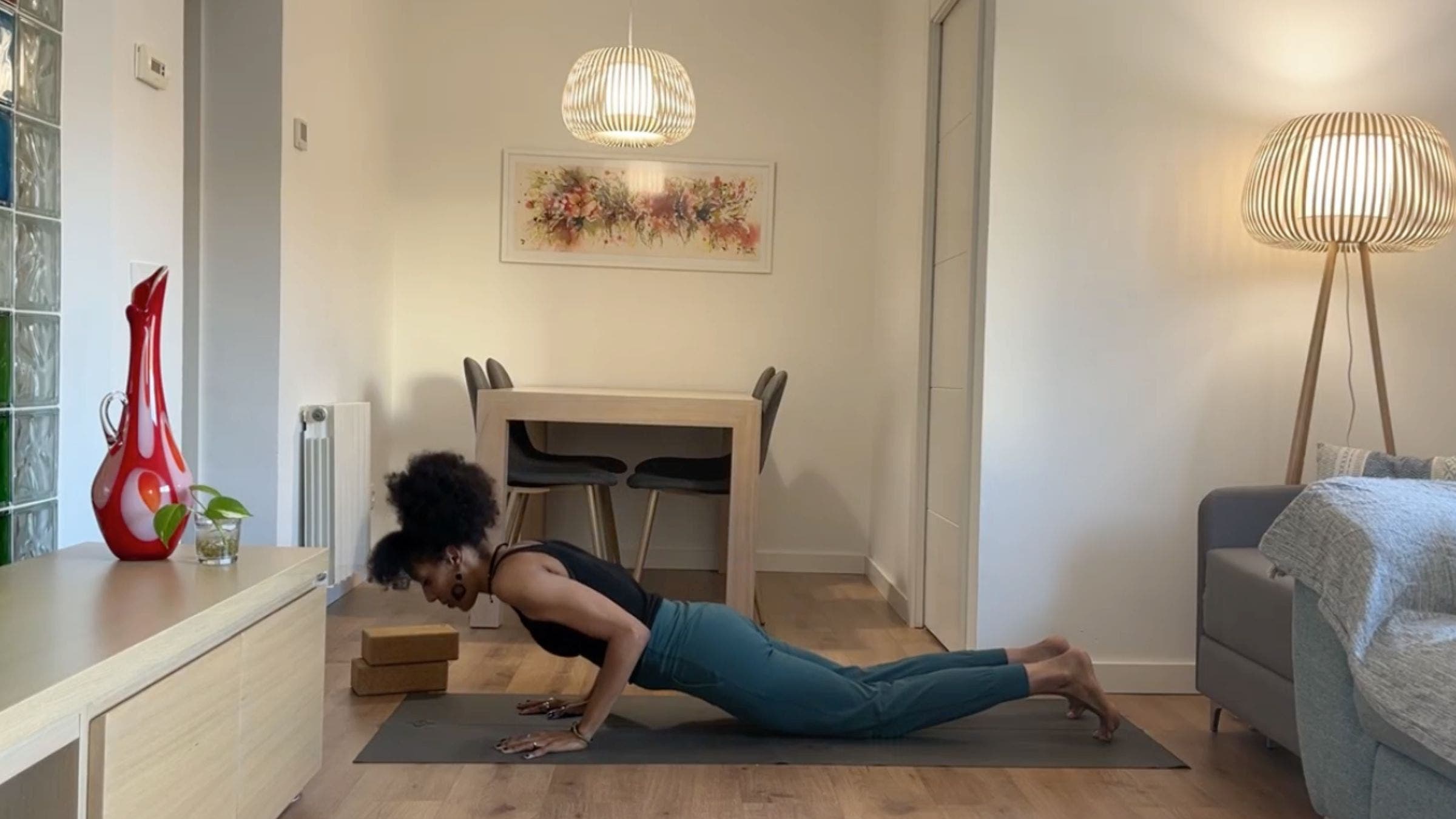 Yoga instructor practicing Chaturanga variation.