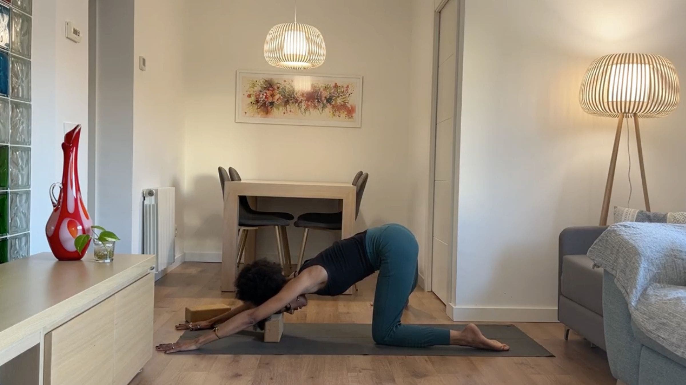 Yoga instructor practicing Gate Pose forward bend.