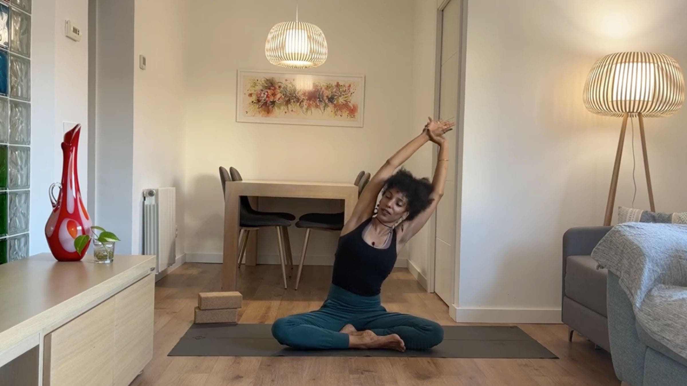 Yoga instructor practicing Seated Side Stretch.