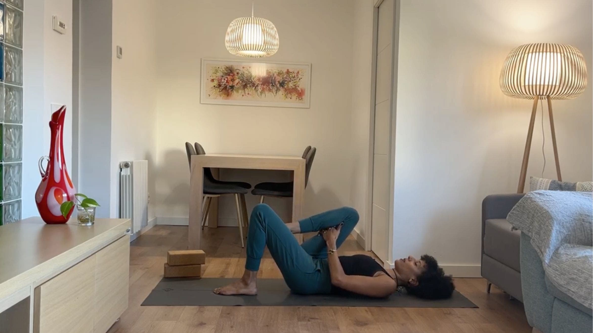 Yoga instructor practicing knee to chest.