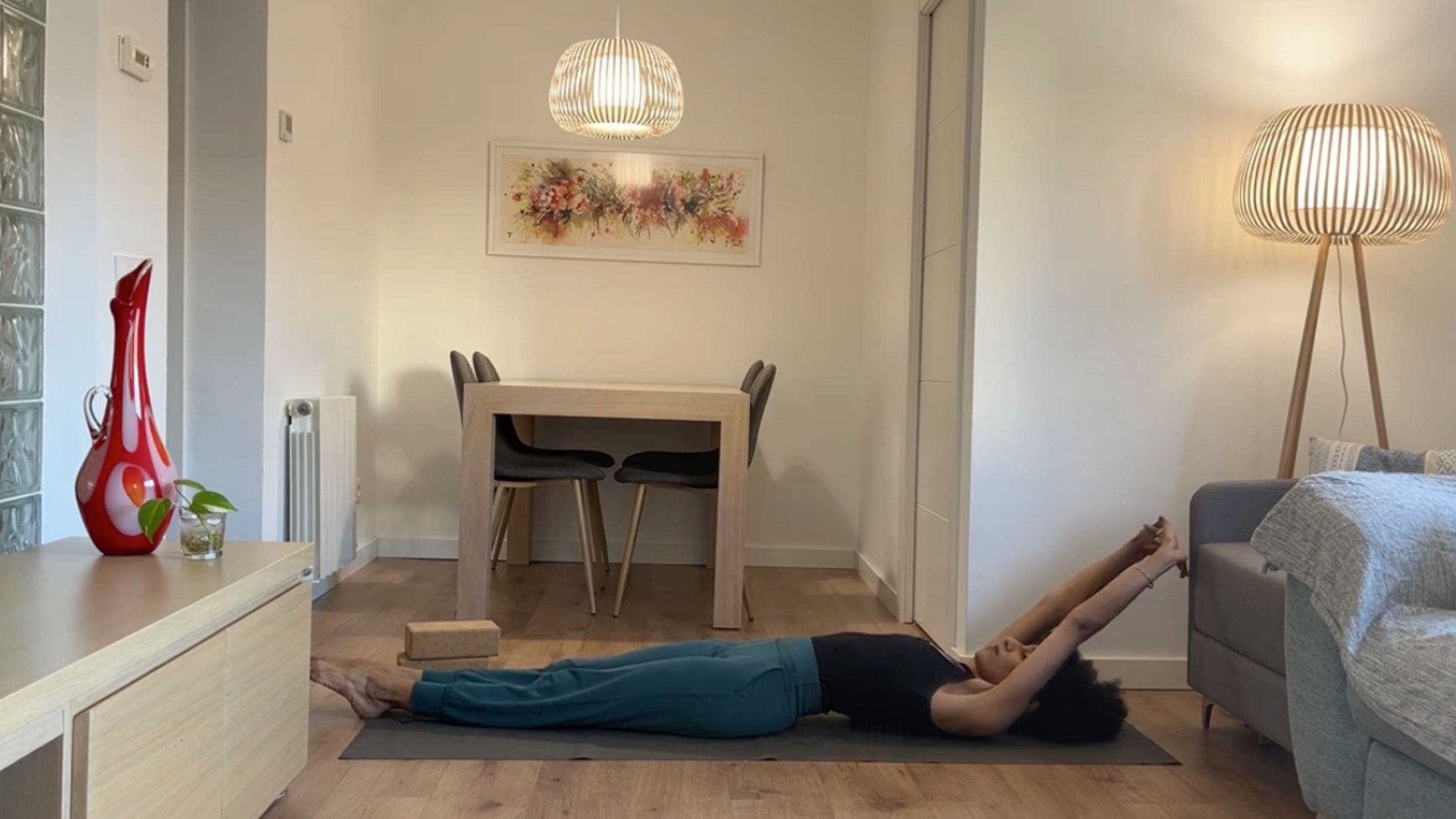 Yoga instructor practicing reclined stretch.