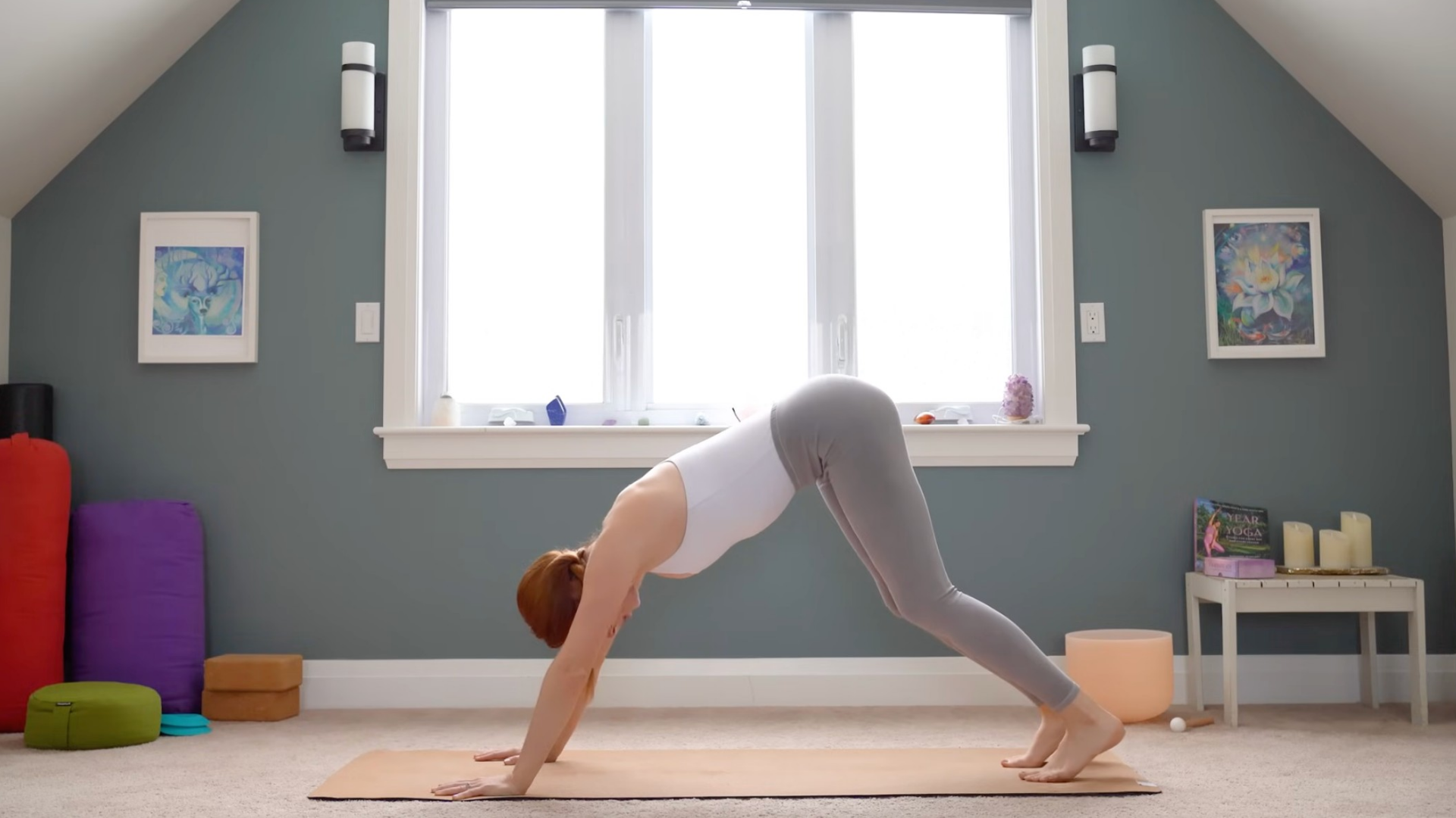 Woman in Downward-Facing Dog on a yoga mat